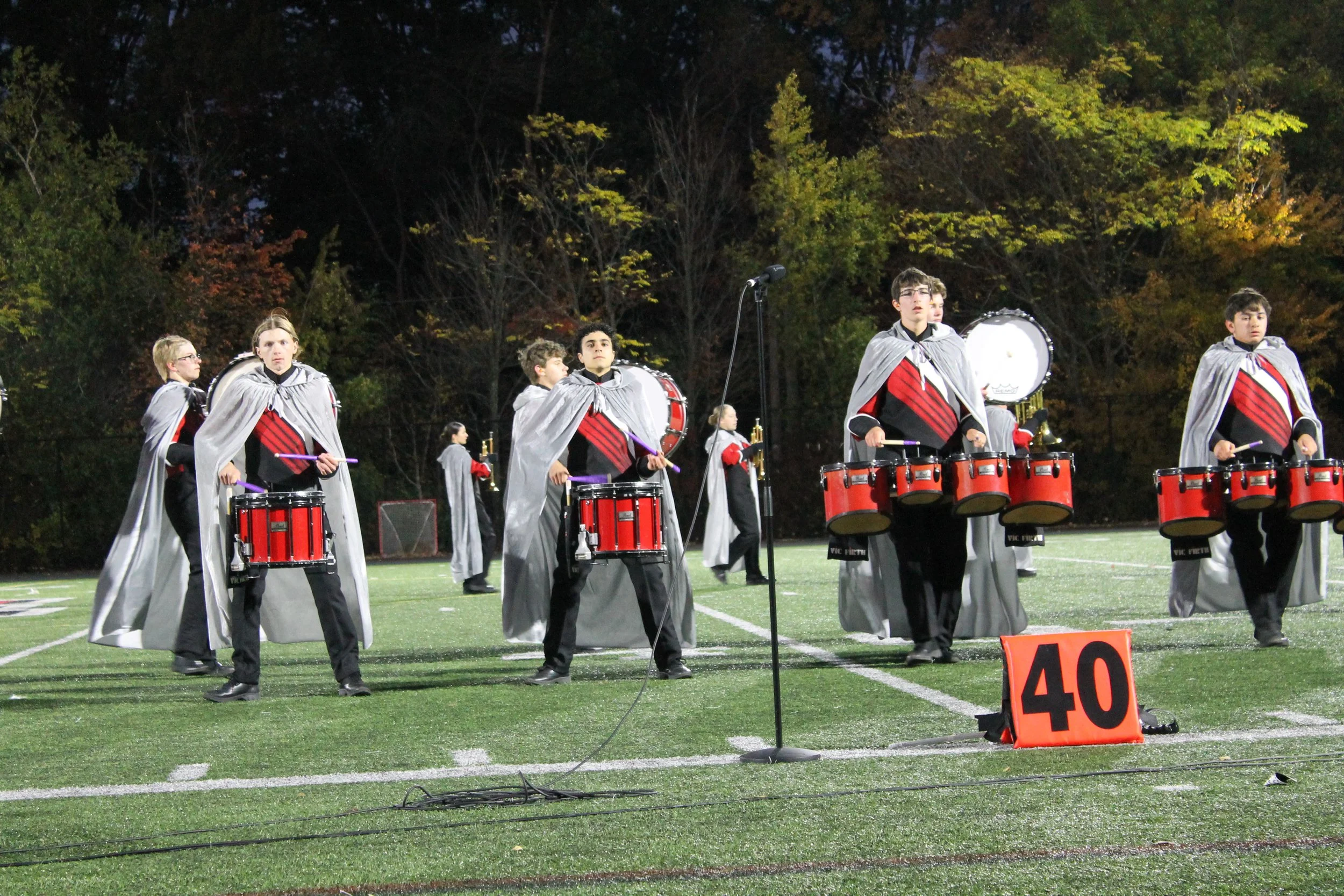 RMHS Marching Band snare drummers in silver capes perform during Saturday’s NESBA competition.