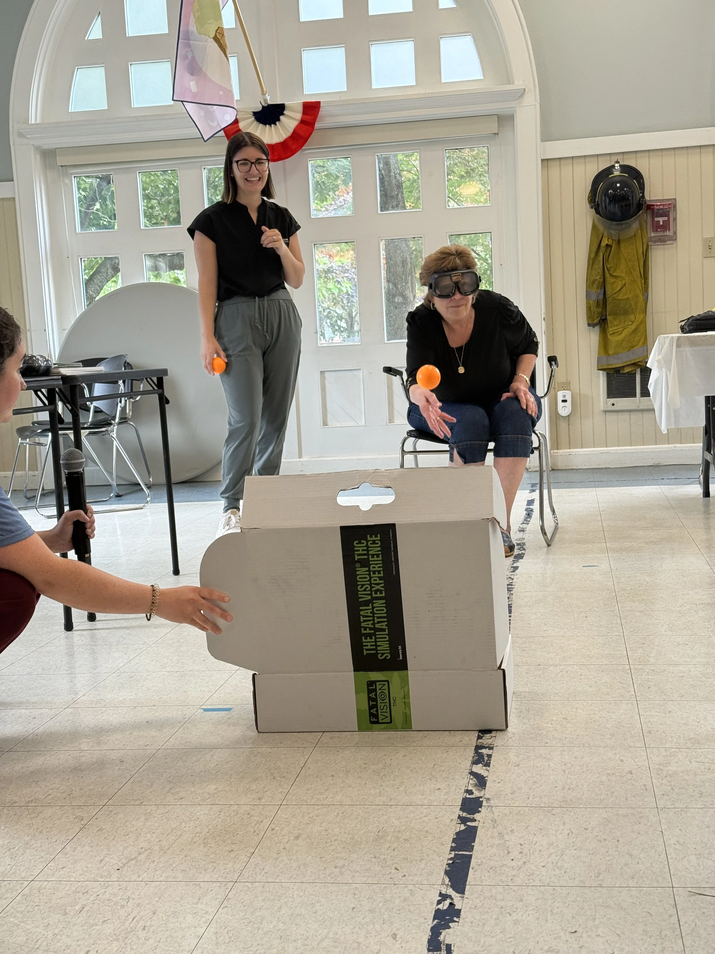 Drunk goggle simulation with the participant tossing the ball into a box.