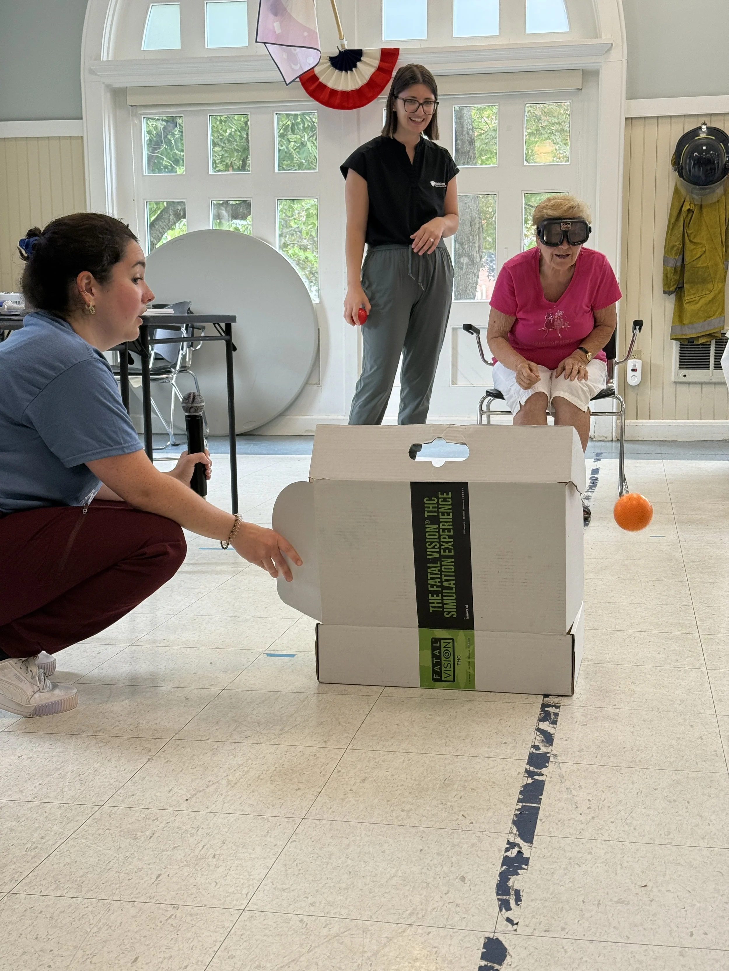 Drunk goggle simulation with the participant tossing the ball into a box.