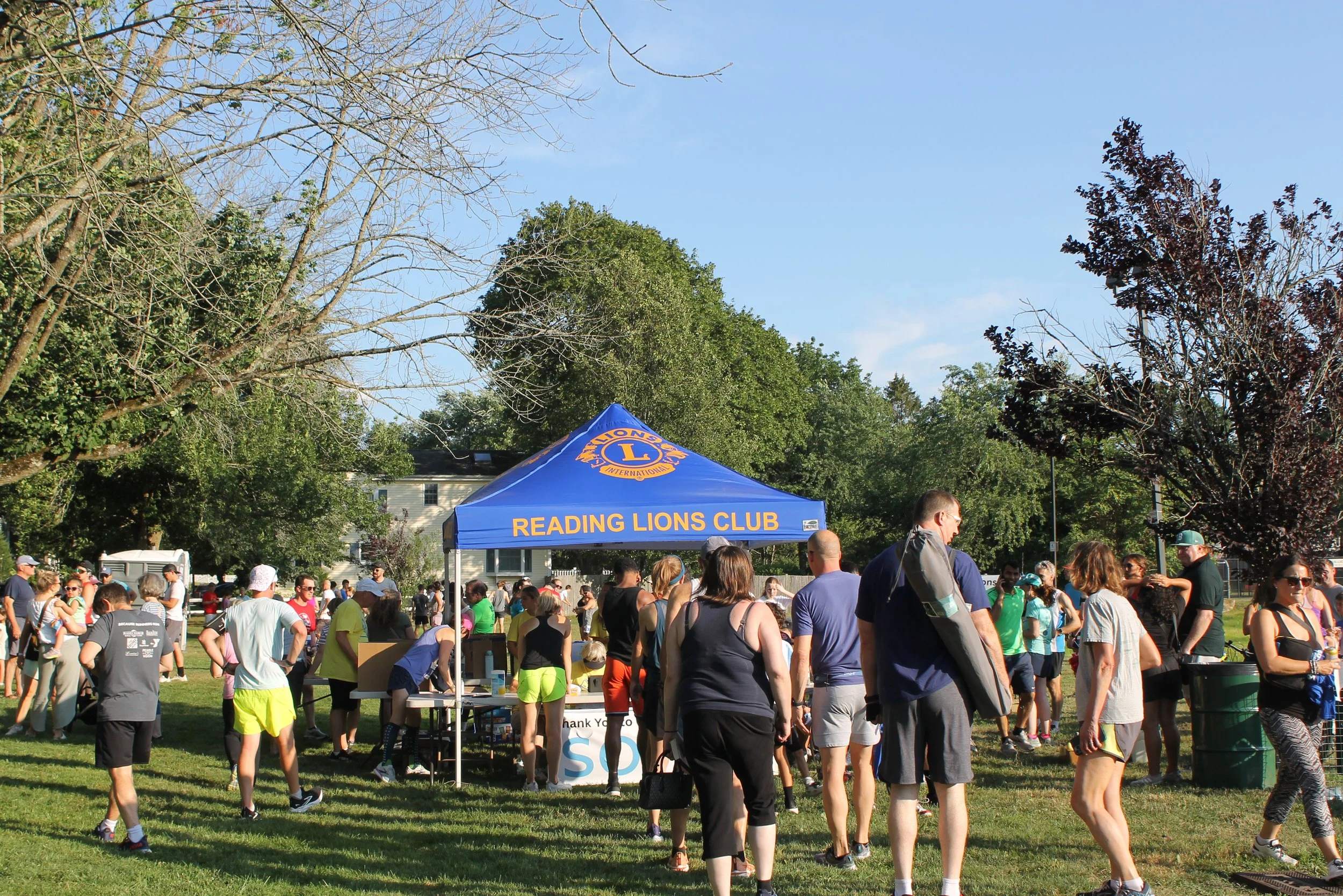 Participants checking in at the Registration Table ahead of the race on July 17, 2025.
