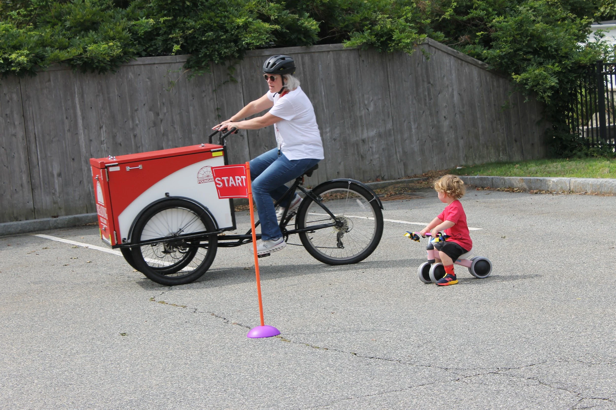 RPL Staff Cate Zannino on the Book Bike with Jaime on his balancing bike.