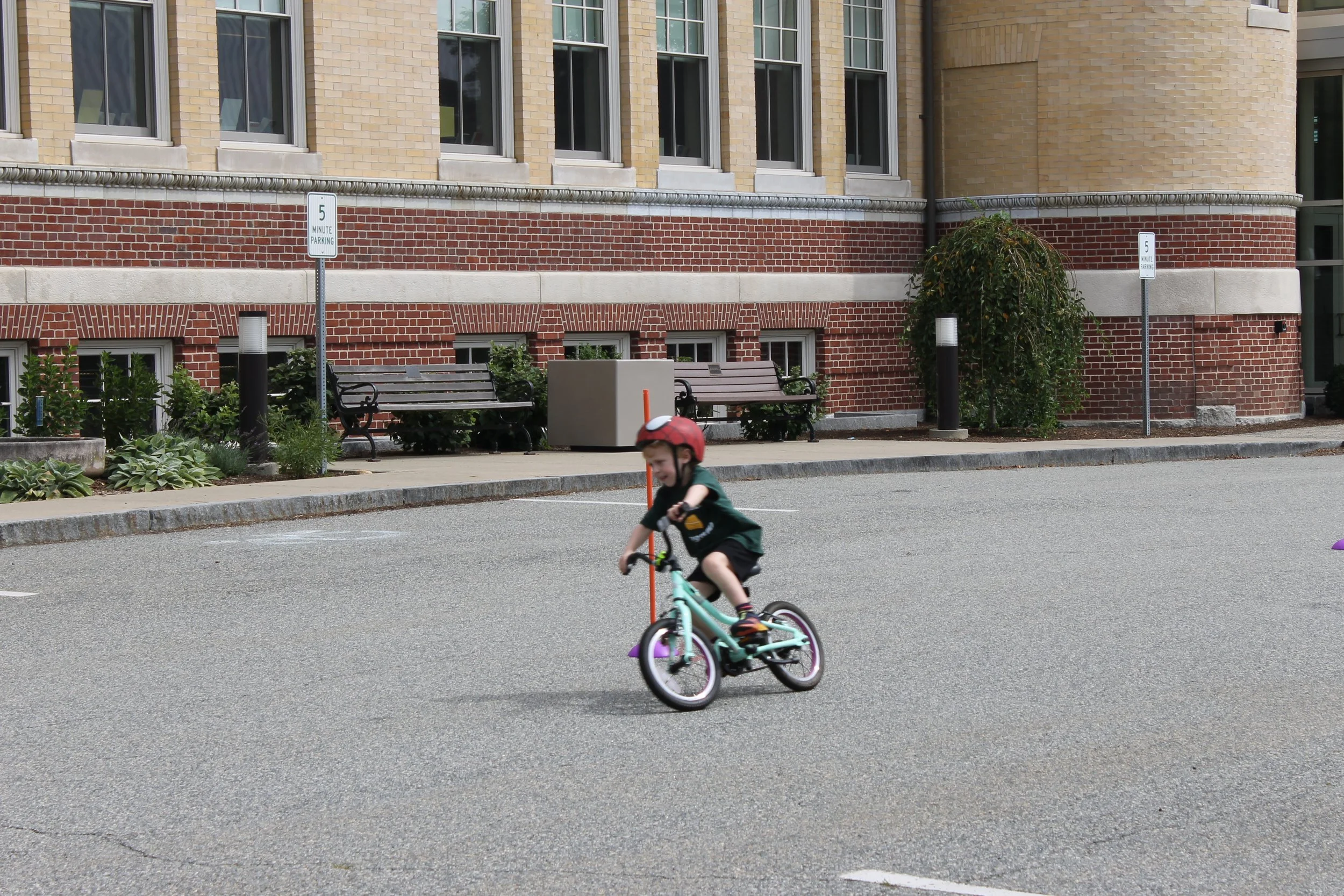 Paticipant Liam zooming through the parade route at the Bike Rally on August 14, 2025.