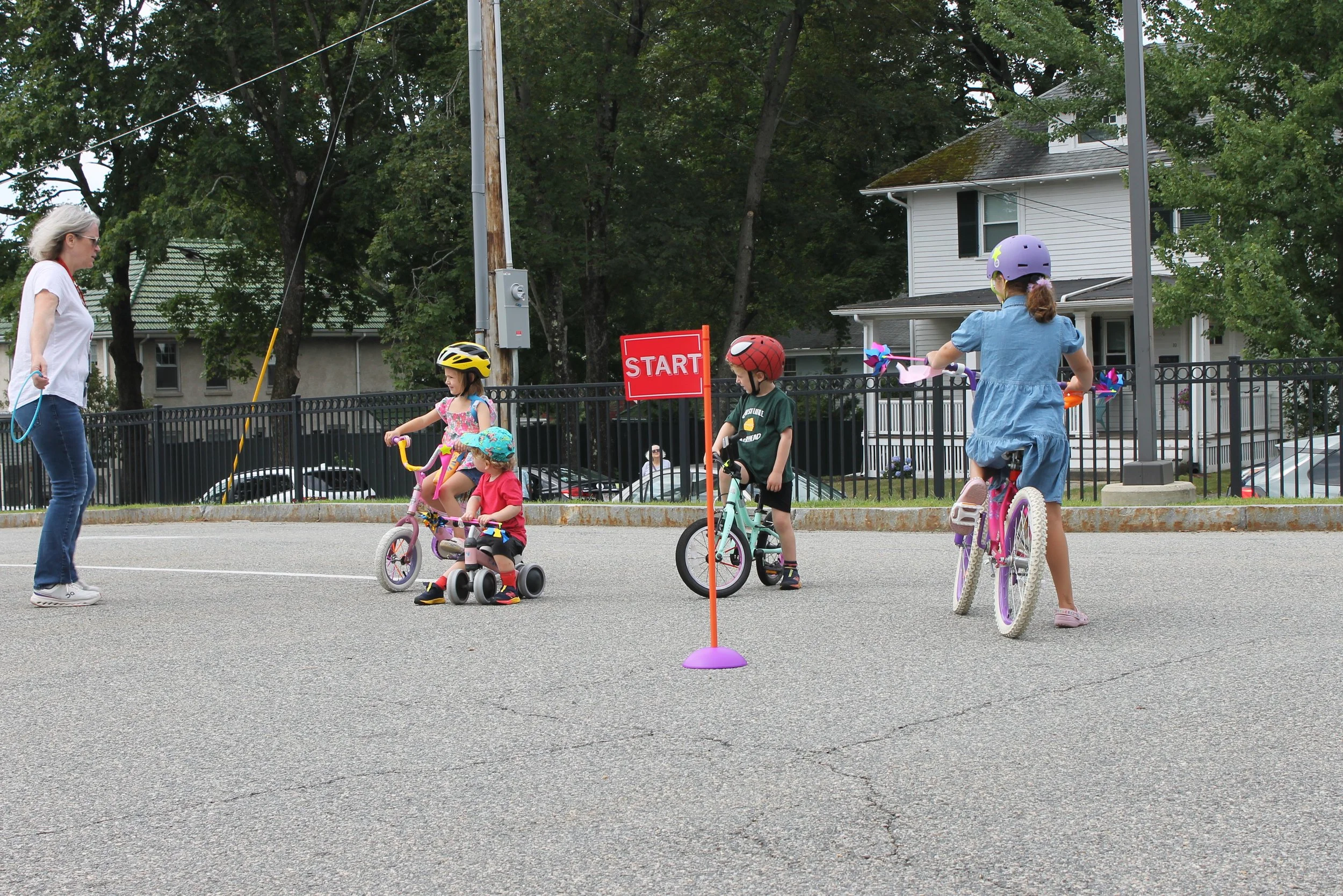 RPL Staff Cate Zannino preparing participants to balance on their bikes to collect the hoop at the Bike Rally on August 14, 2025.
