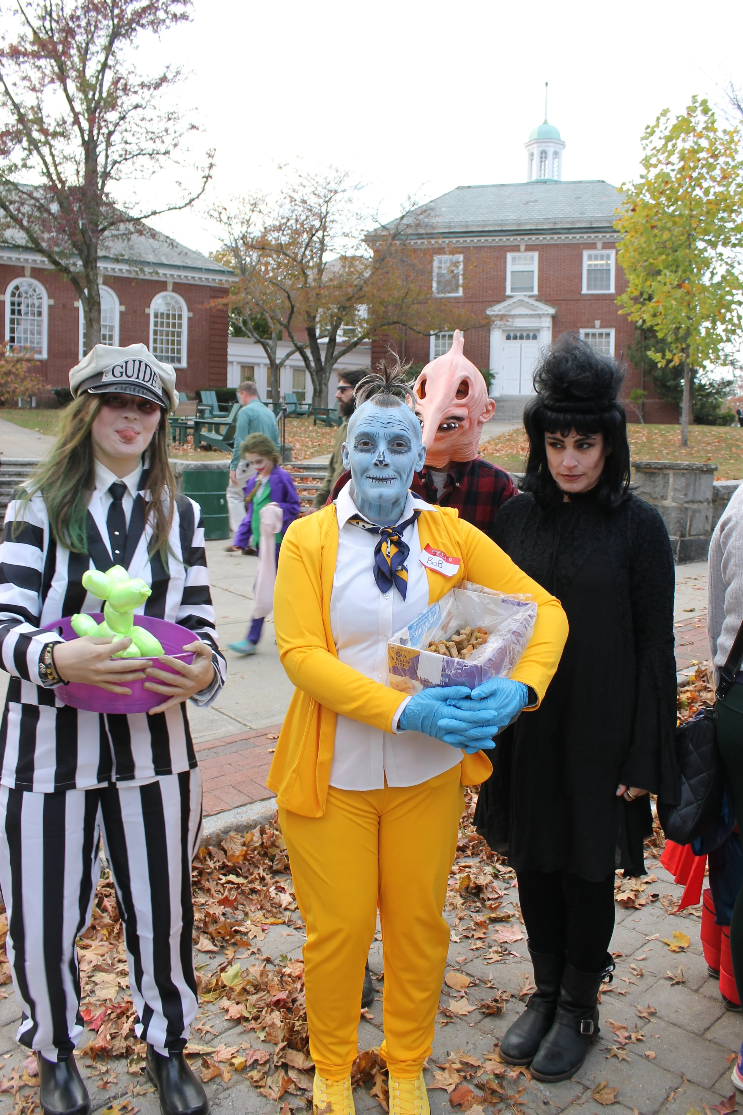 Creative costumes of adults passing out candy on the Common  during downtown trick-or-treat.