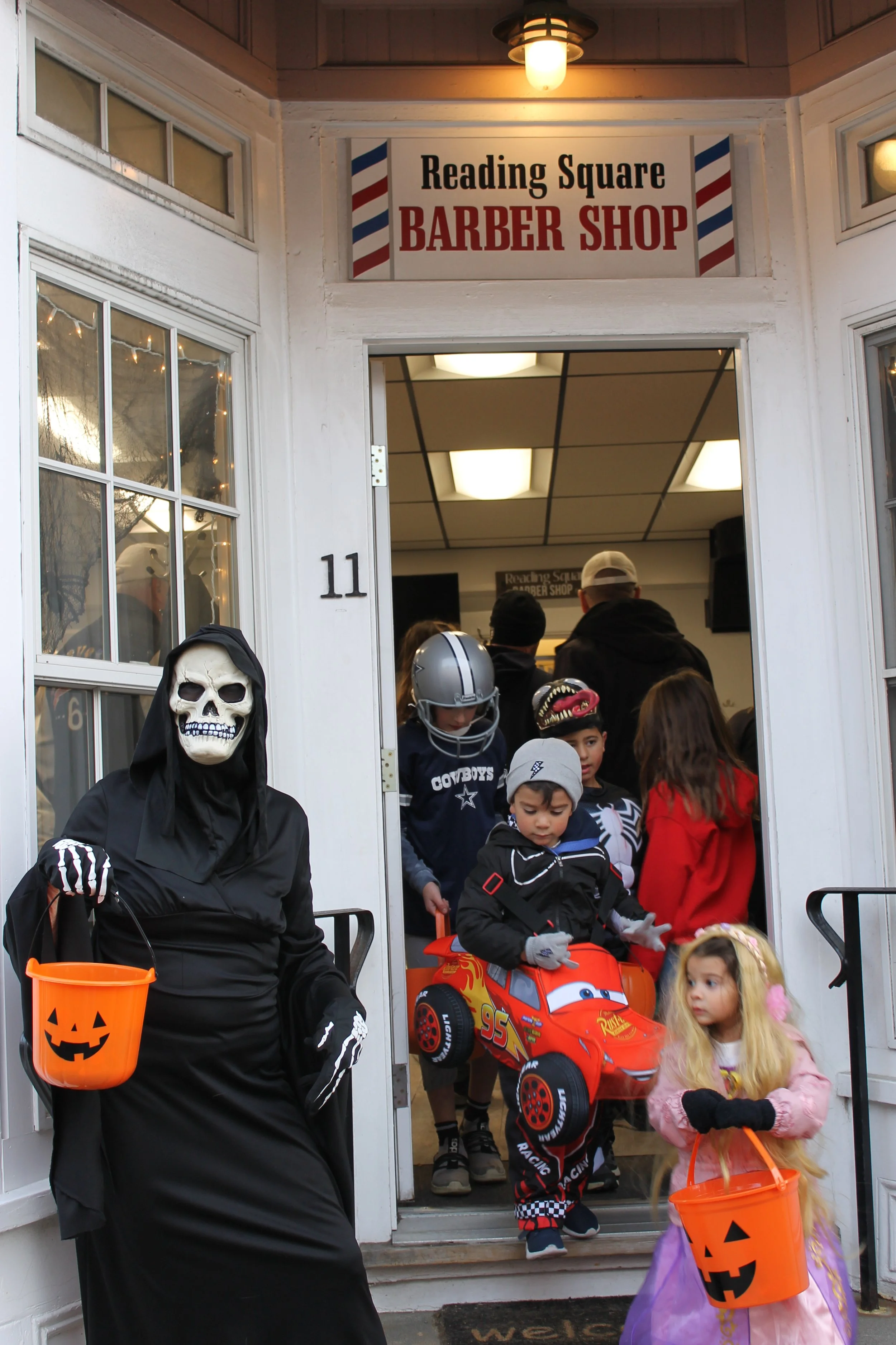 Kids at the Reading Square Barber Shop during downtown trick-or-treat.