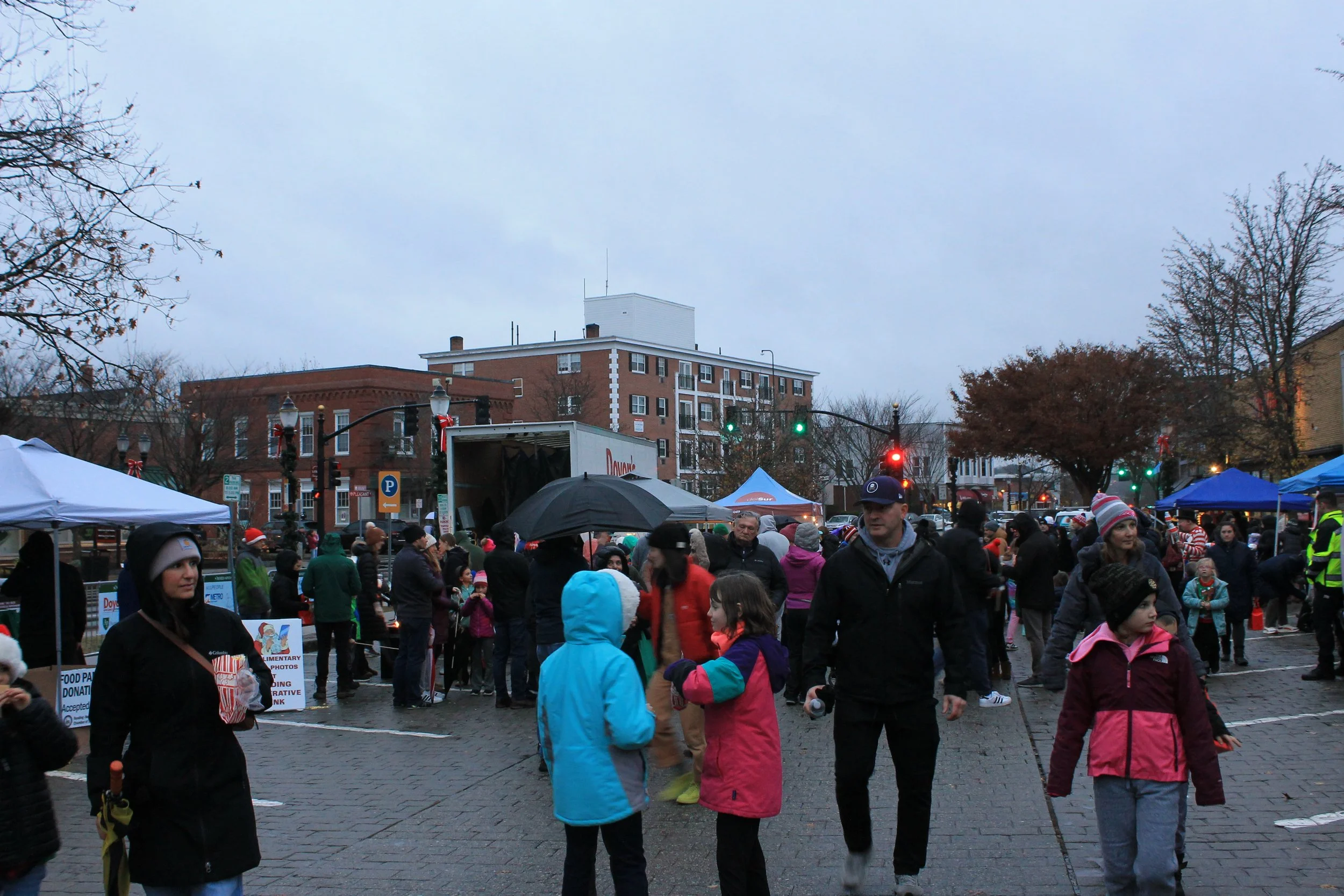 Crowds gathering on the cobblestone downtown at the Tree Lighting Ceremony on the Town Common.