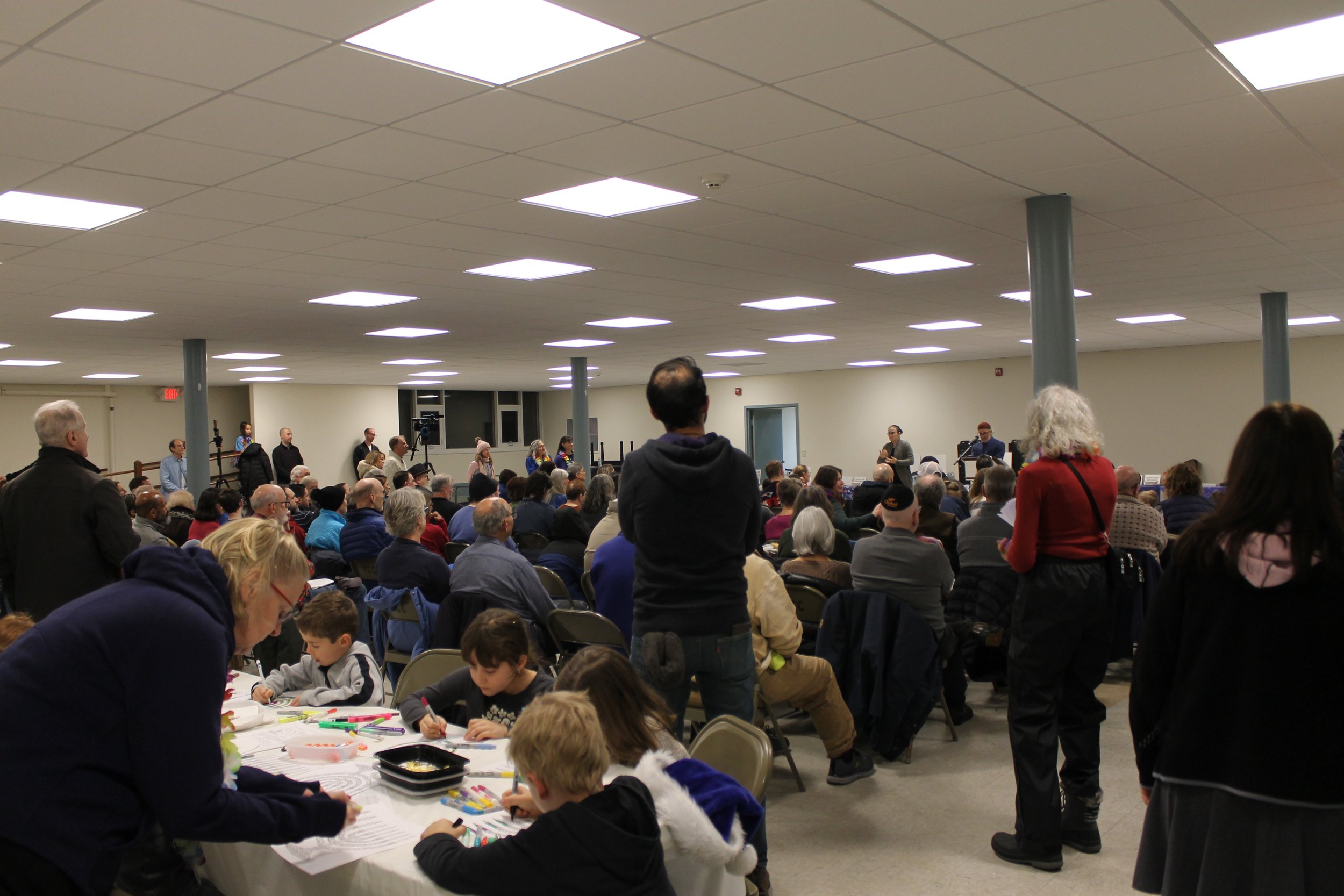 Attendees observing the program at the Menorah Lighting.