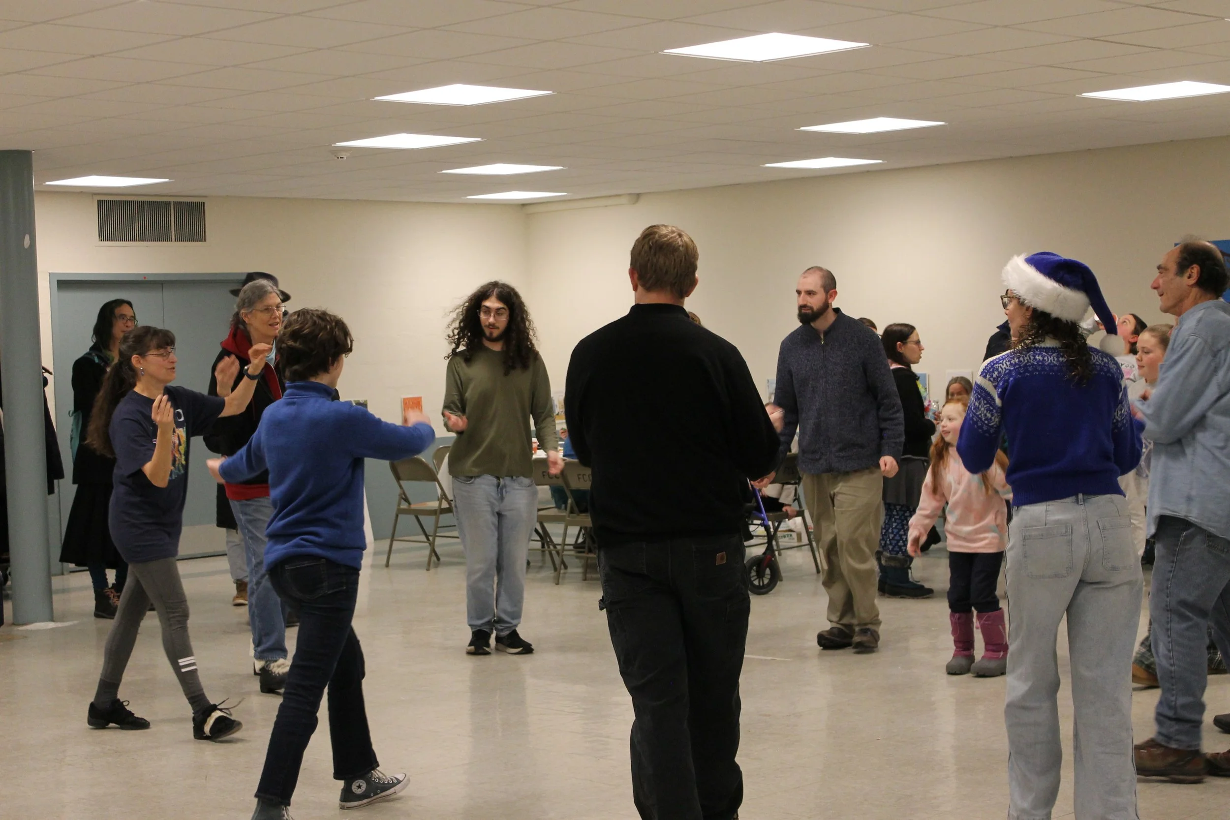 Anne Schwartz teaching Israeli folk dancing at the conclusion of the program at the Menorah Lighting.
