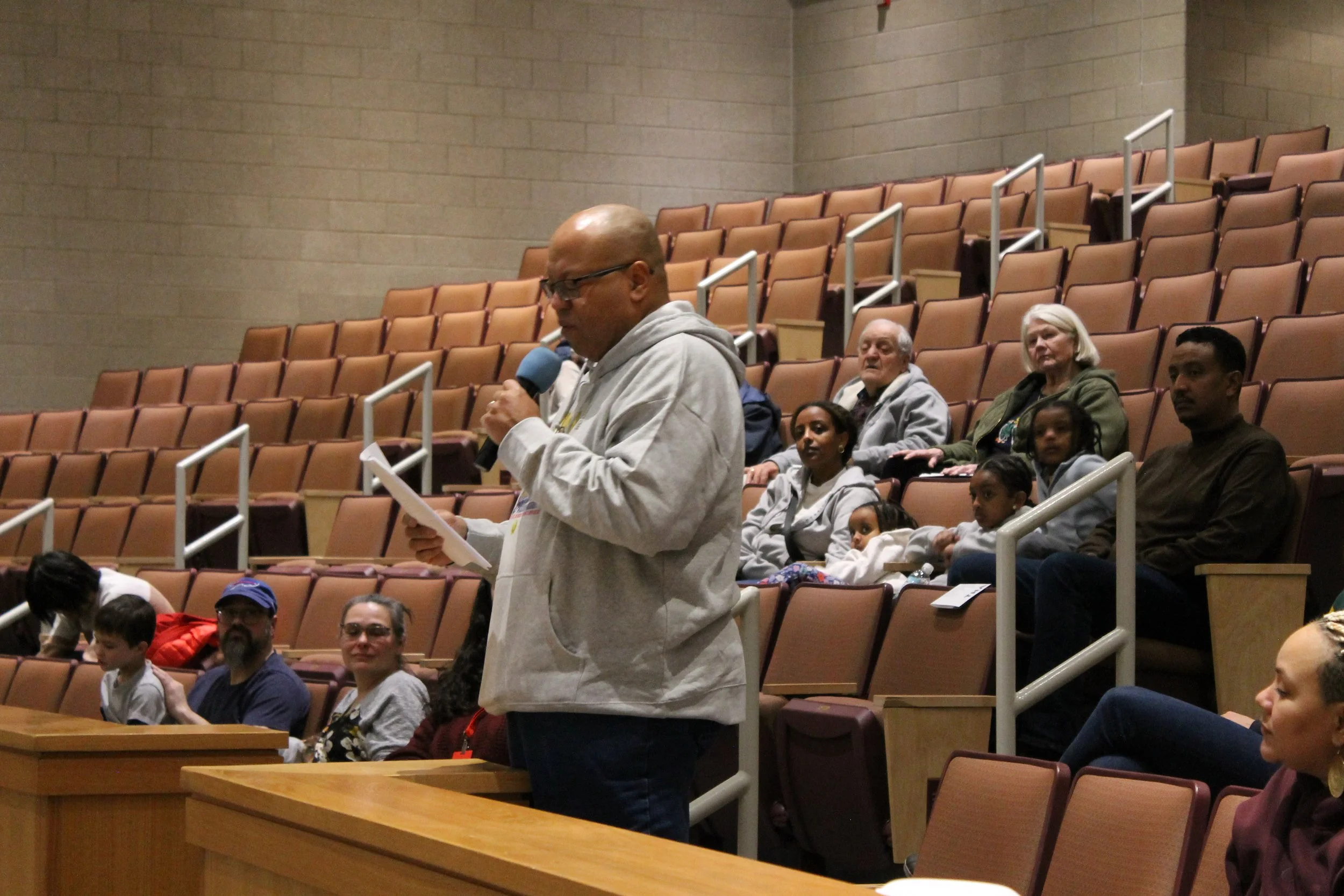 Audience member Reggie Nichols reads an excerpt from a speech by Dr. Martin Luther King Jr. during Reading's MLK Day program at RMHS.