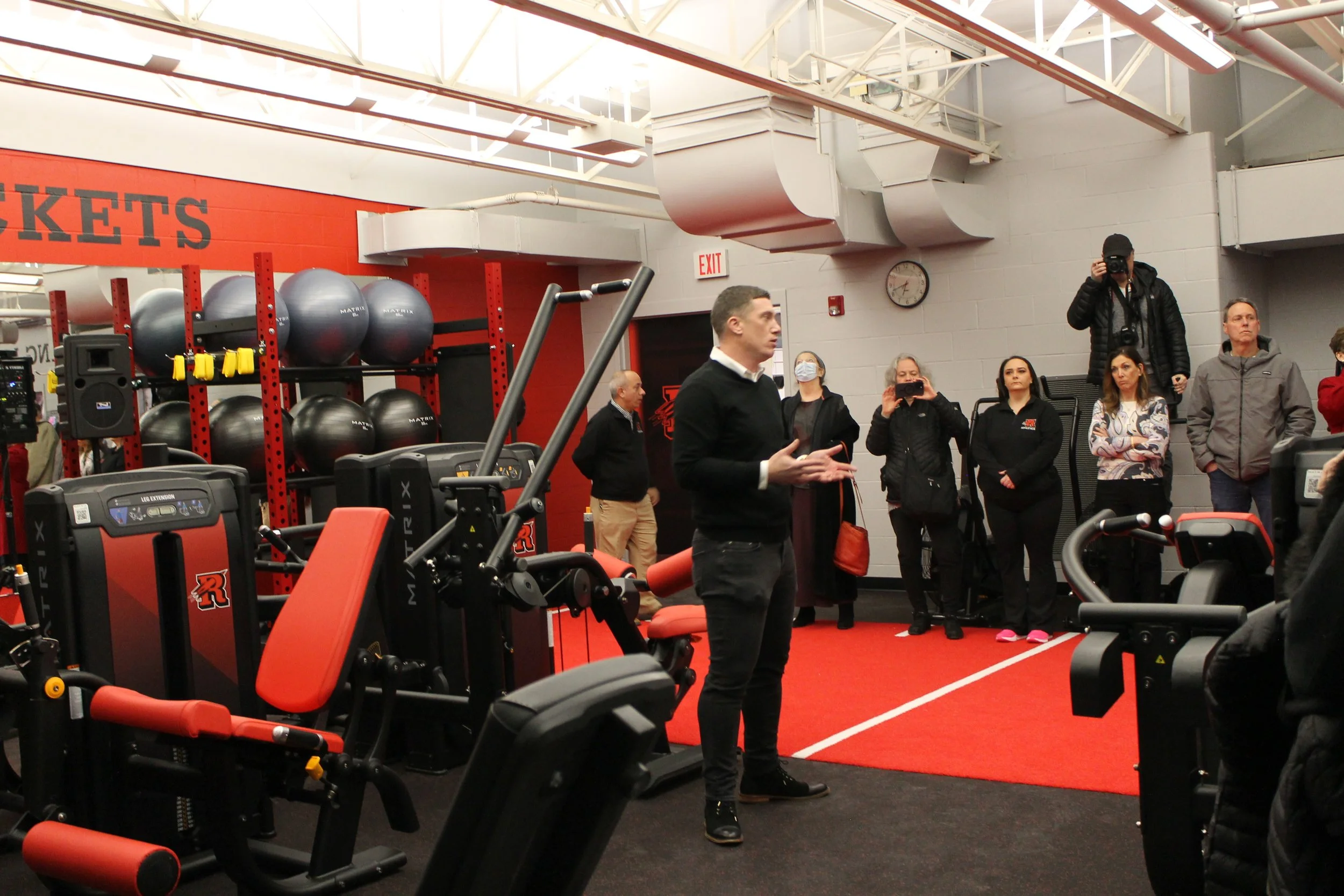 Nick Sweat explaining that the redesigned weight room includes modern racks, platforms, and training stations.