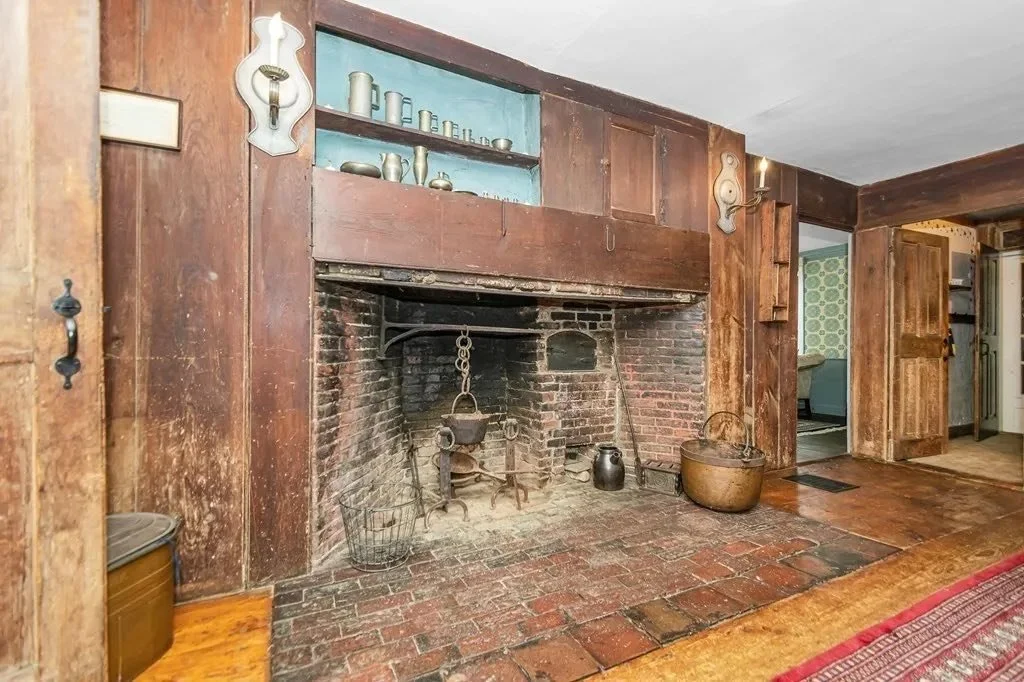 Original hearth and wood-paneled room inside 52 Salem Street, reflecting the home's 18th-century construction and period features.