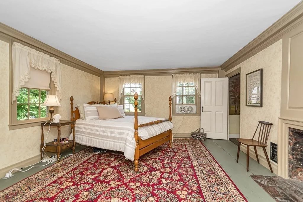 One of the preserved bedrooms in the Parker House, featuring wide plank floors, period trim, and traditional New England design elements.