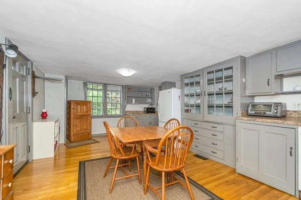 Kitchen and dining space at 52 Salem Street, blending historic character with later updates while maintaining original structural elements.