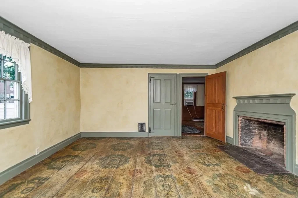 Wide view of the home's stenciled flooring, a rare decorative feature that preservationists are exploring options to salvage and protect.