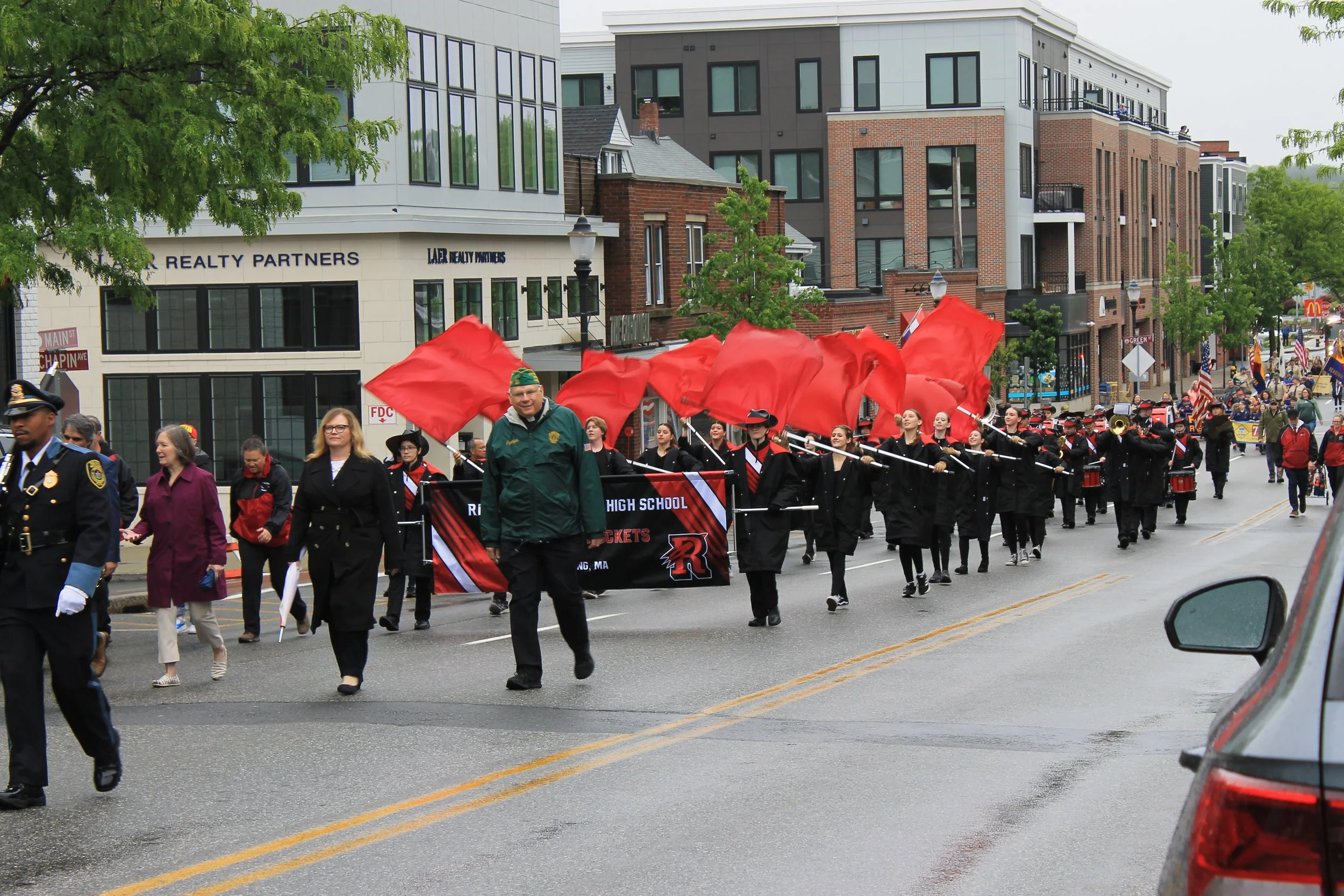 Town officials and veterans march ahead of the RMHS Color Guard and Marching Band on Main Street.