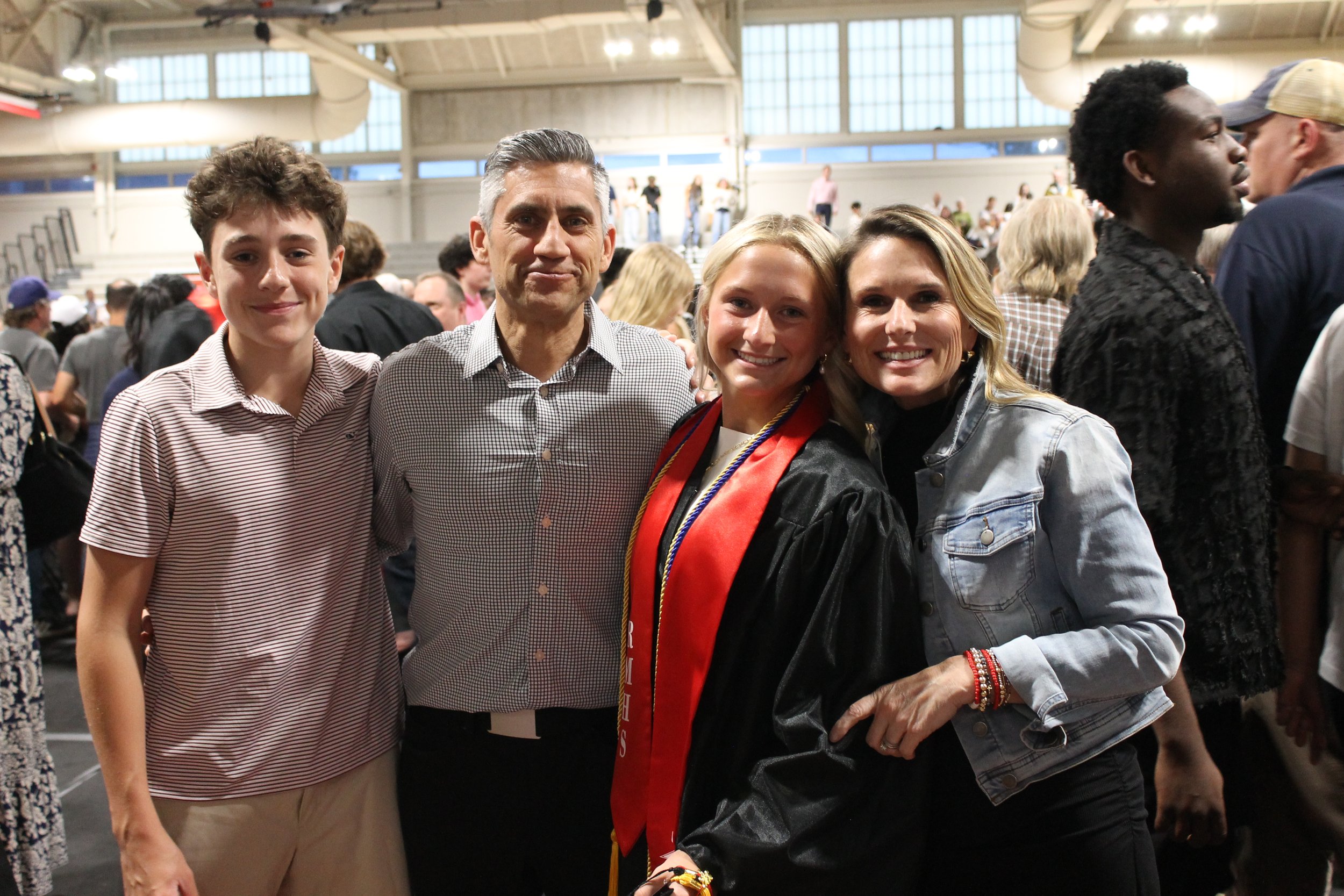 Graduate Ellie Russo shares a moment with family after the ceremony concludes.