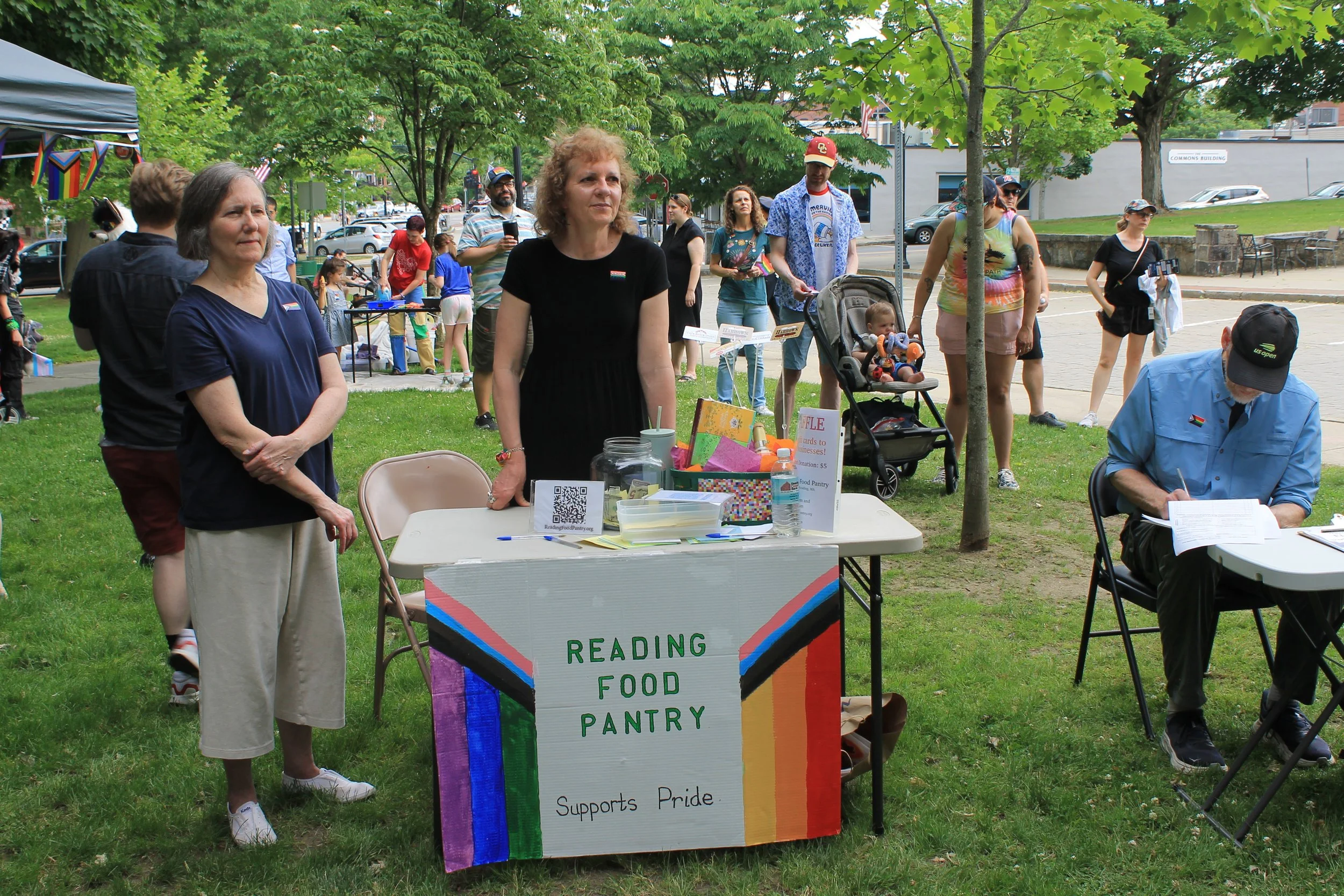 Select Board Vice Chair Karen Rose-Gillis and Executive Director Simone Payment staff the Reading Food Pantry table at the Pride celebration.