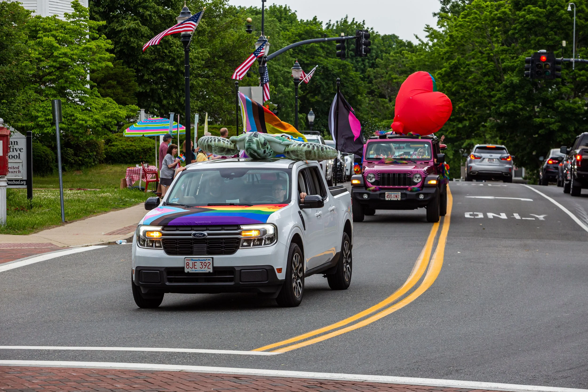Decorated cars roll through Reading during the Pride car parade, including the winner of the Best Decorated Car.