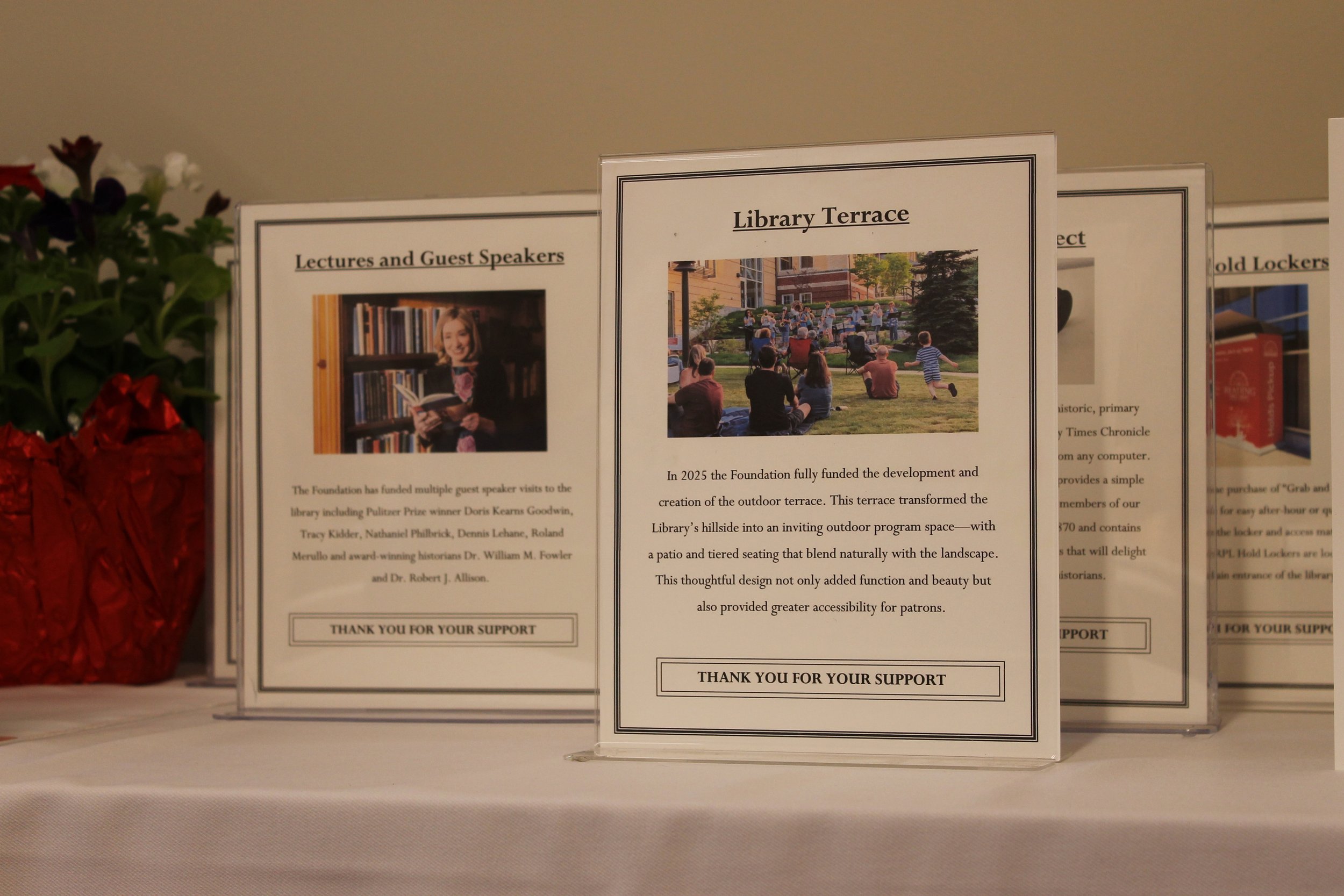 Tabletop displays highlight programs funded by the RPL Foundation over the past 30 years, including the Library Terrace, lectures, and guest speakers, and the book bike.