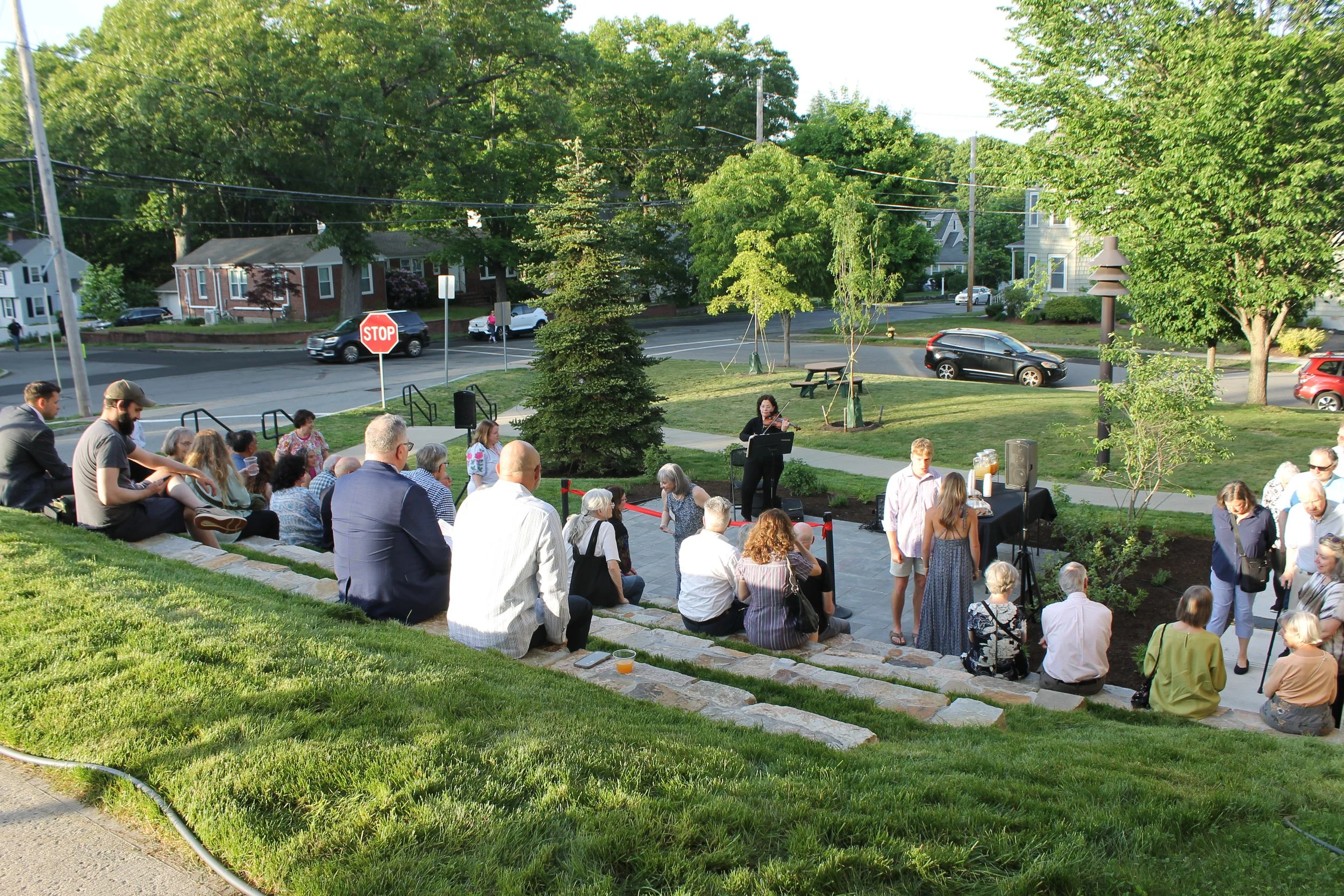 Community members gather on and around the new Library terrace as violinist Kenya performs.