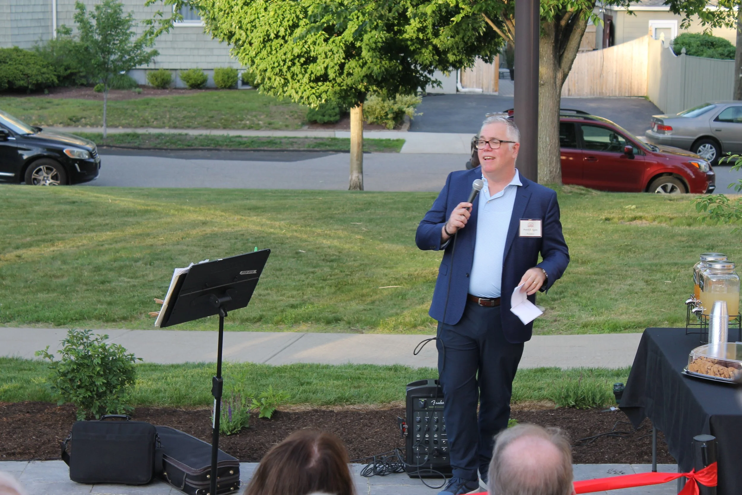 Pat Egan addresses the crowd on the new Library Terrace, praising the ad hoc landscape committee and community support that made the project possible.