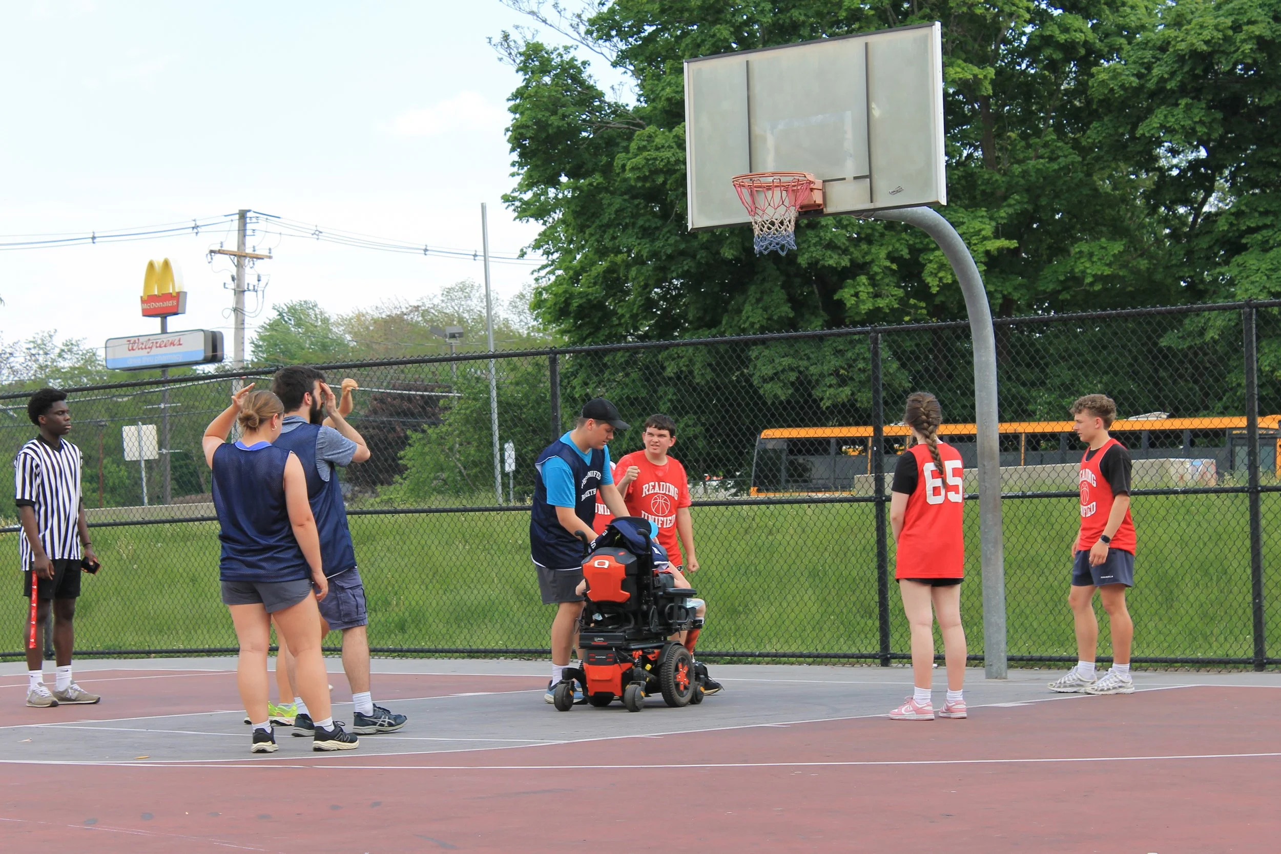 A Wilmington player sets up his teammate in a wheelchair to shoot a basket.