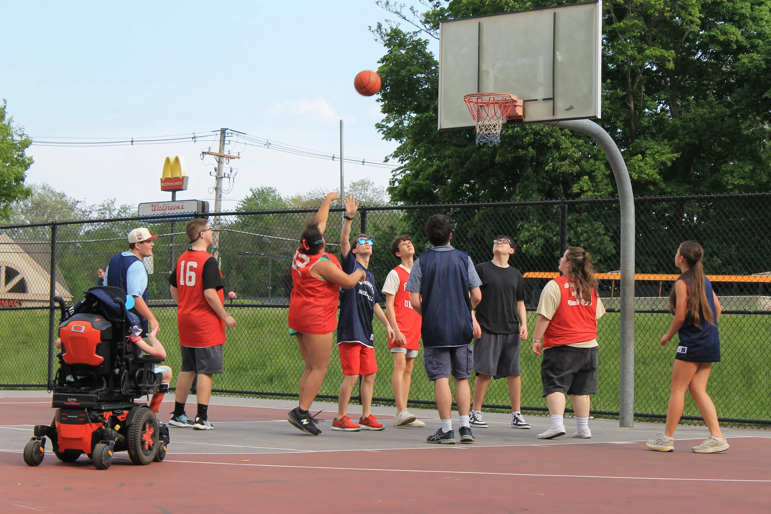 A Reading Unified player goes up for a shot as teammates watch the ball in flight.