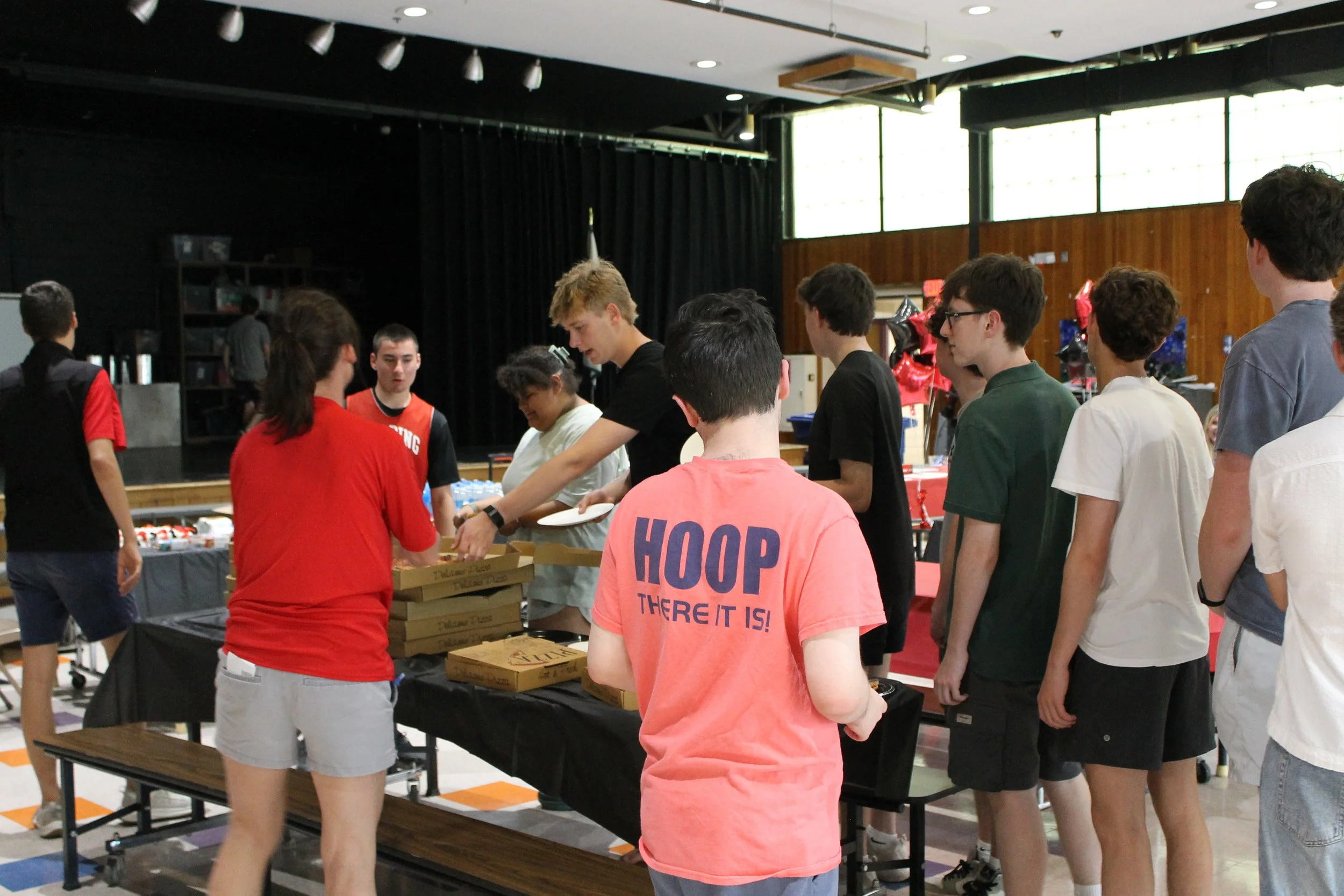 Players line up for pizza and refreshments during the banquet.