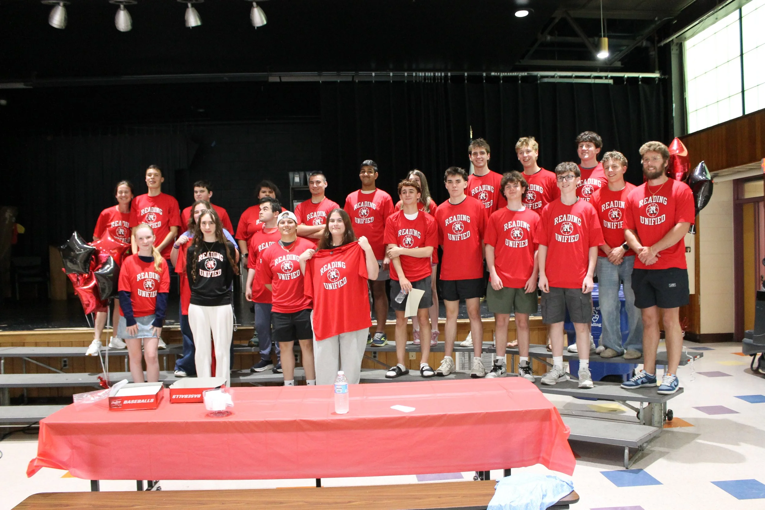 The Reading Unified team gathers on stage to pose with their new team shirts.