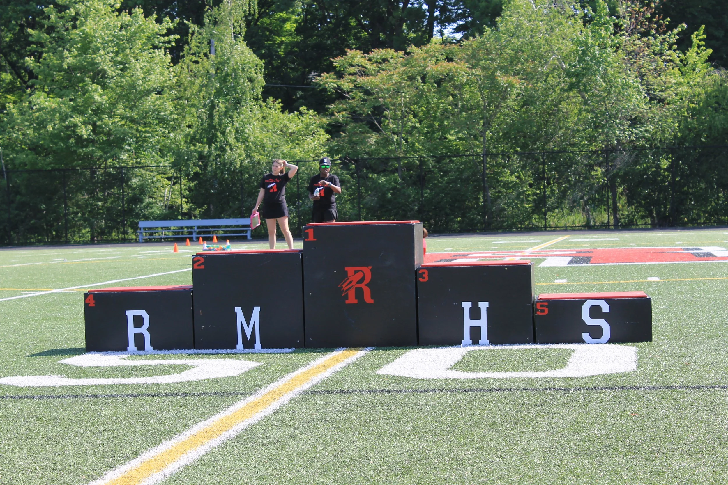 The winner's podium, spelling out RMHS, awaits athletes on the football field.
