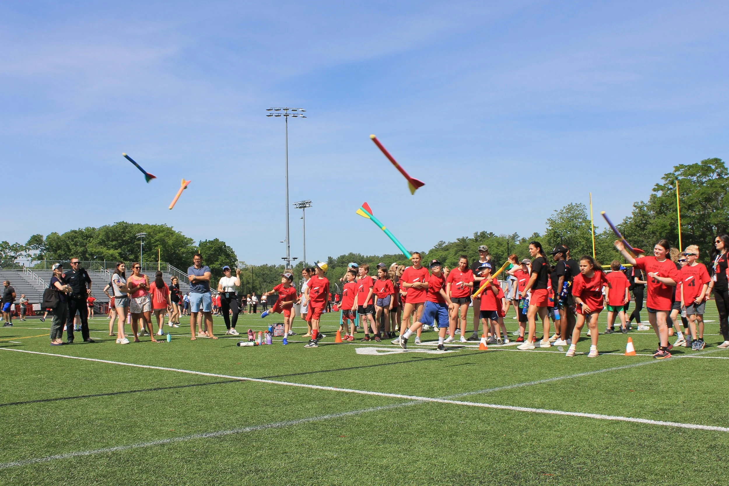 Athletes launch foam rockets into the air during the rocket throw event.