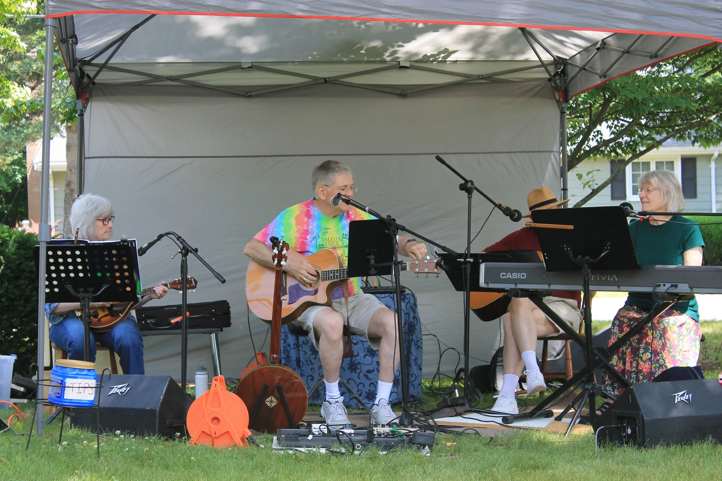 The Neighbors plays for the crowd under their tent setup.