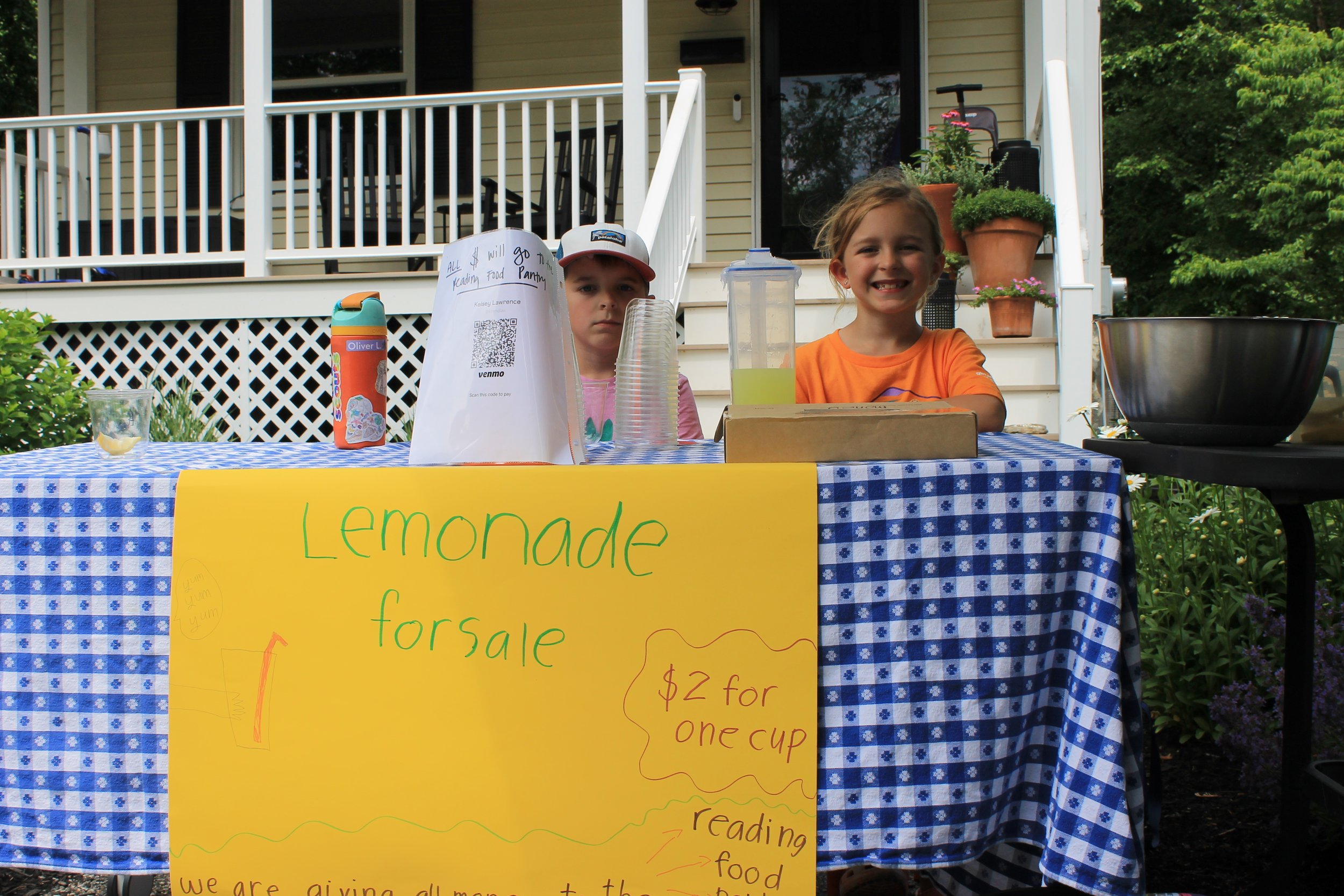Young kids raise money for the Reading Food Pantry with a lemonade stand.