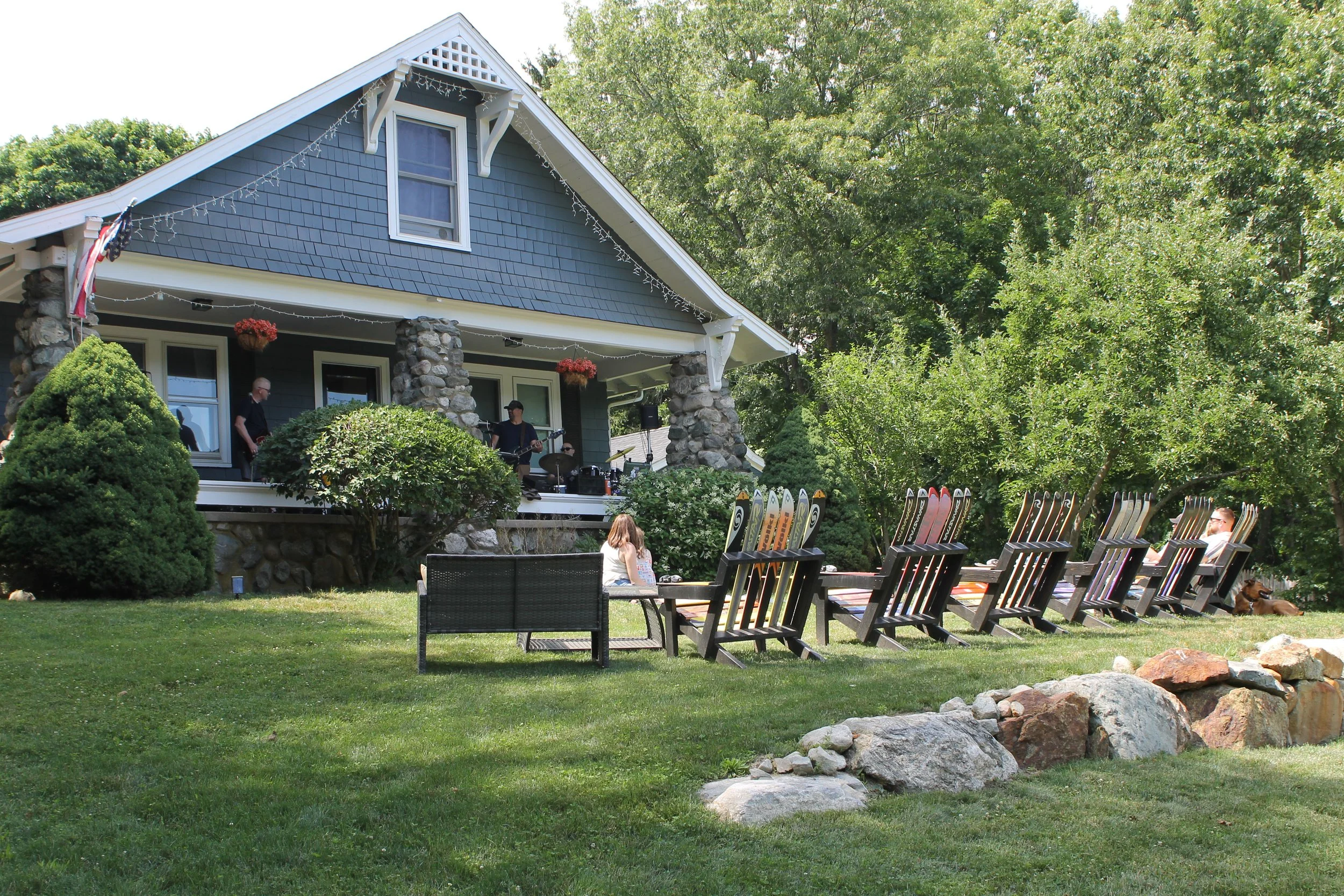 Generation Know plays on the porch o 121 Willow Street with recycled ski Adirondack chairs.
