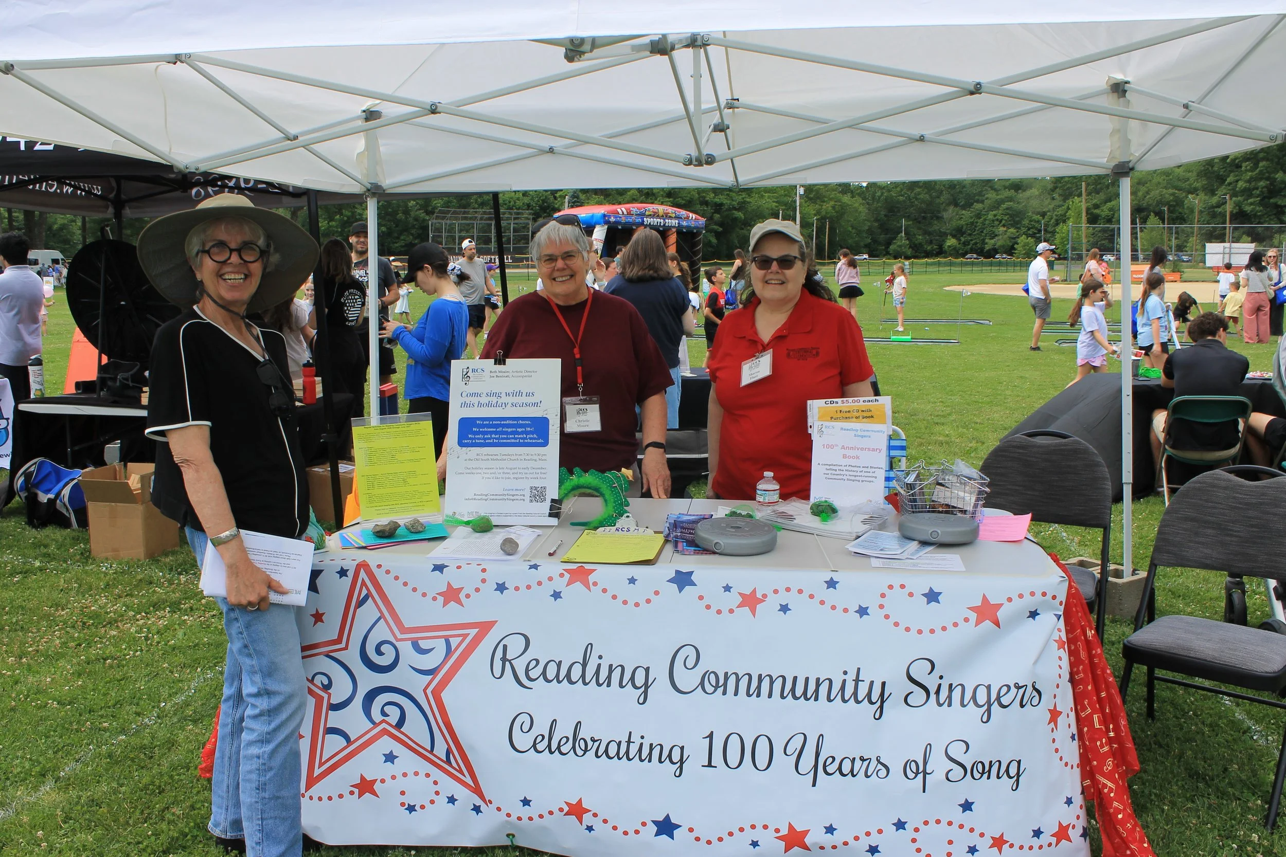 Reading Community Singers volunteers welcome visitors and celebrate the group's 100th anniversary season.