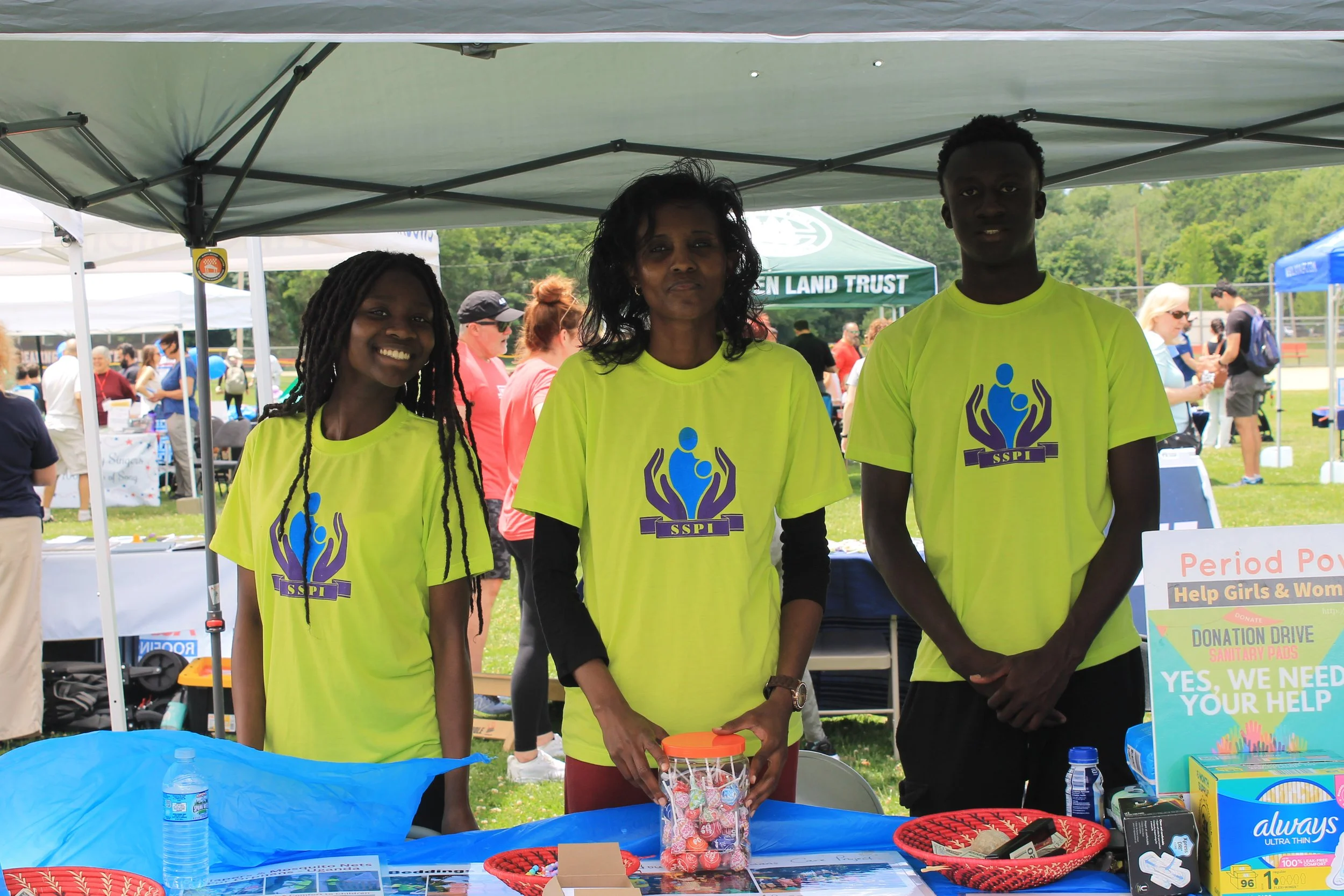 Volunteers from Supporting Single Parents International (SSPI) staff their tent, collecting donations for their Period Power Drive.