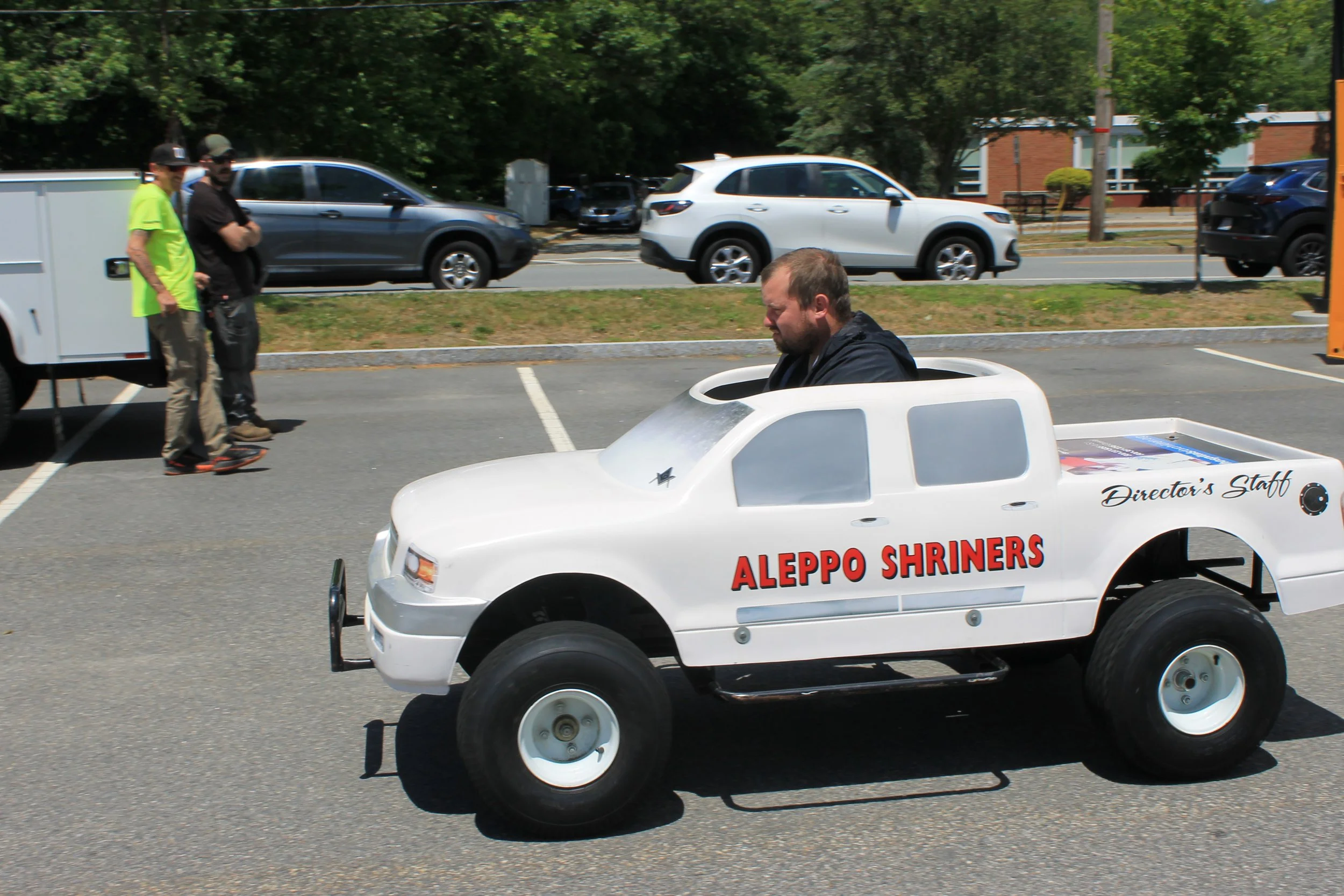 An Aleppo Shriners mini truck cruises through the lot.