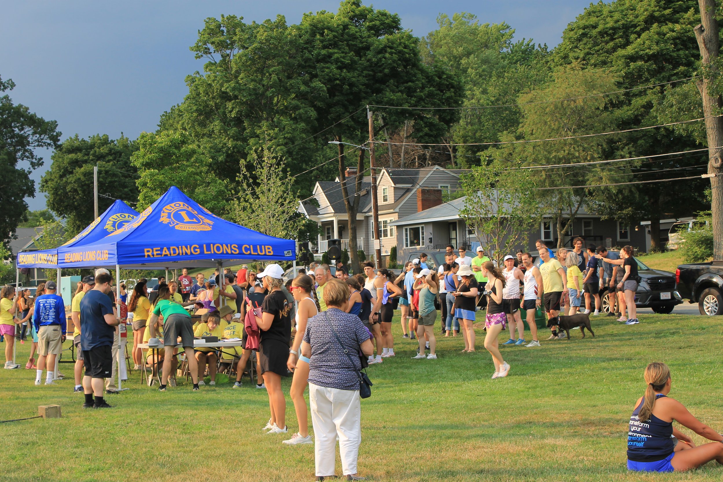 Runners, walkers, and families gather near the Reading Lions Club tents at Memorial Park as check-in ensues up ahead of the start.
