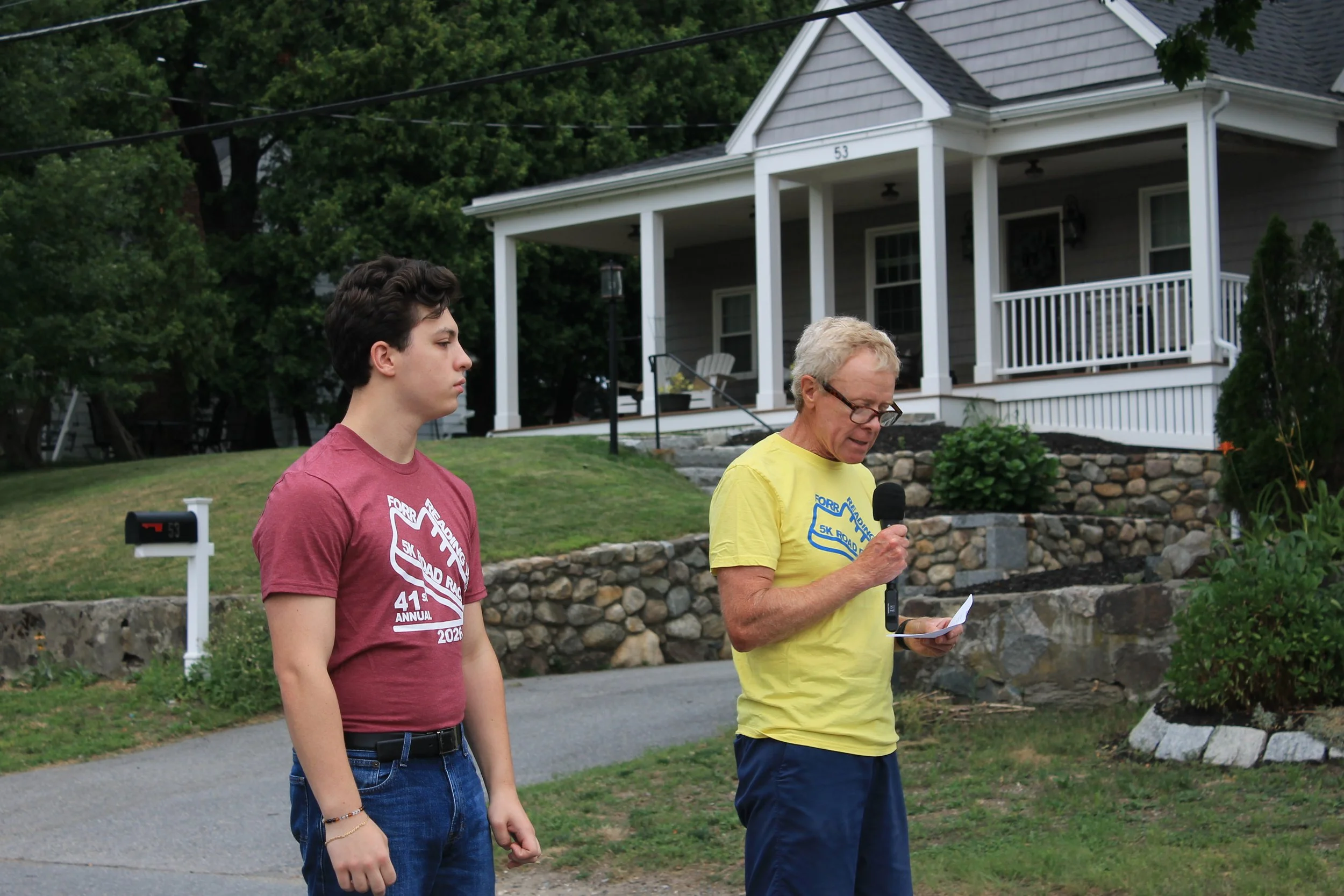 The Journey For Sight 5k co-director Tom Clough (right) delivers opening remarks to the crowd before the start, joined by RMHS student Adam Hogan.
