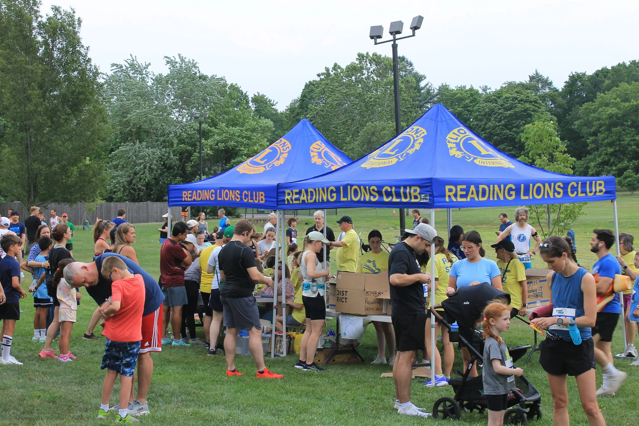 Participants line up at the Reading Lions Club tents to grab bibs and shirts.