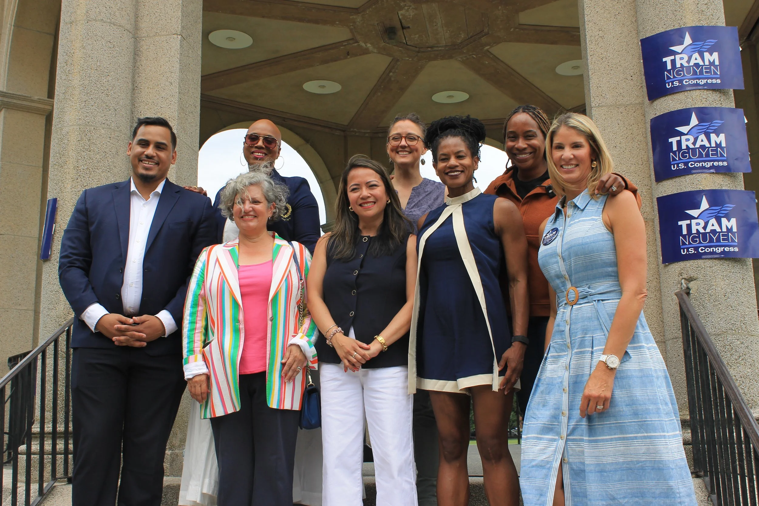  Speakers at the Nguyen rally. Back (l to r): Rep Ayanna Pressley, Dr. Mariah Lancaster, AG Andrea Joy Campbell. Front (l to r): Rep Manny Cruz, Rep Dawne Shand, Rep Tram Nguyen, Rep Lydia Edwards, and Rep Lori Trahan.  Photo by Taylor Gregory. 