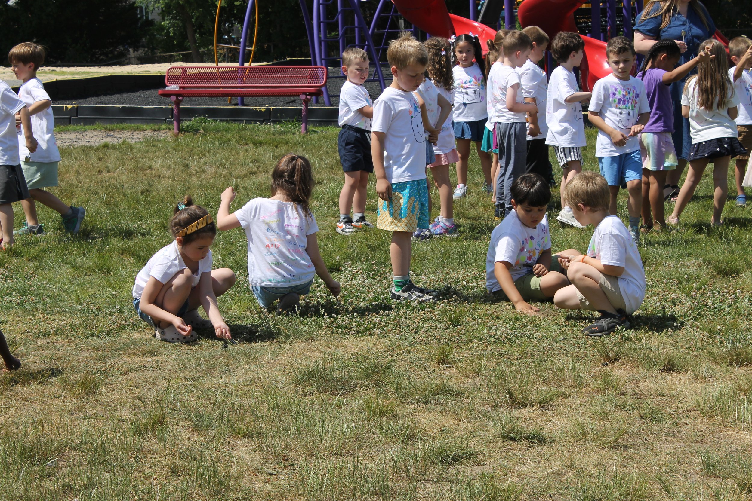 Killam staff guide students through the school's back field for the groundbreaking activity.
