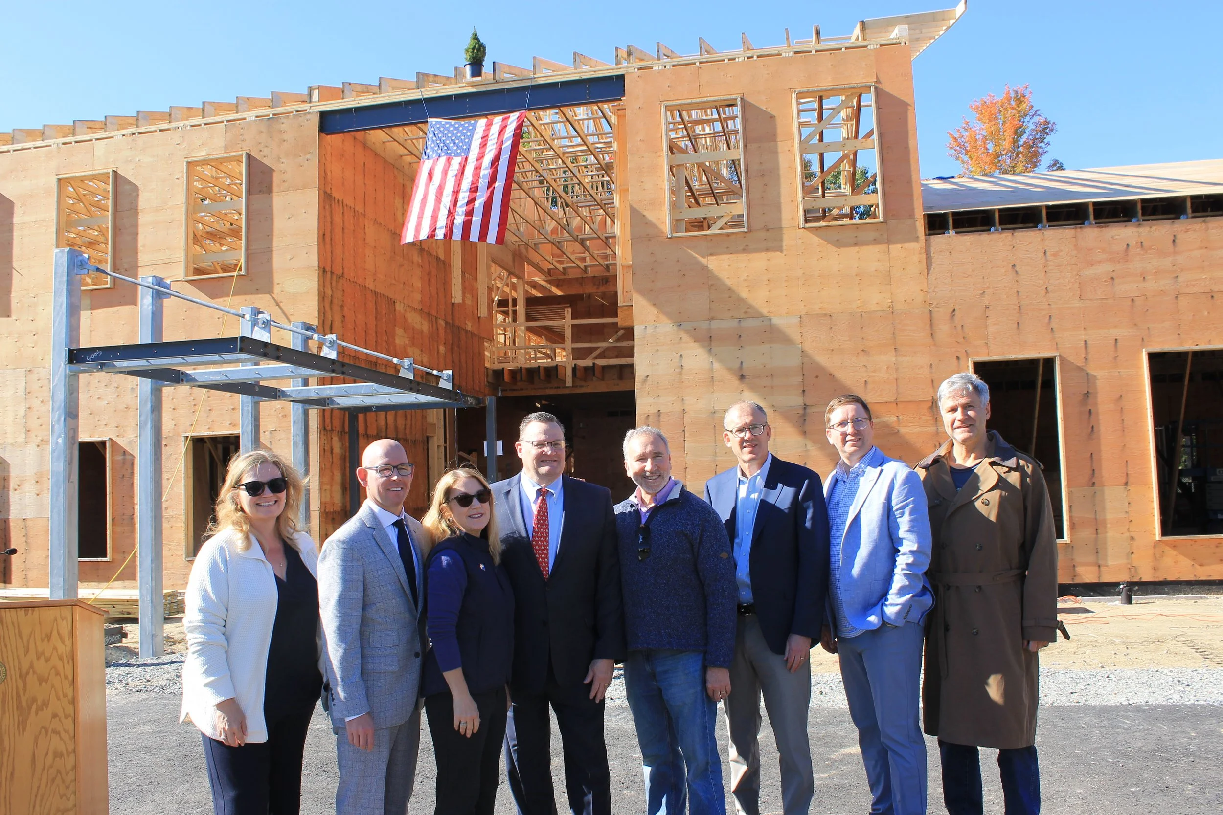 Town Manager Jayne Wellman with the Reading delegation, including state and local elected leaders, and committee members pose in front of the ReCAL building after the ceremony.