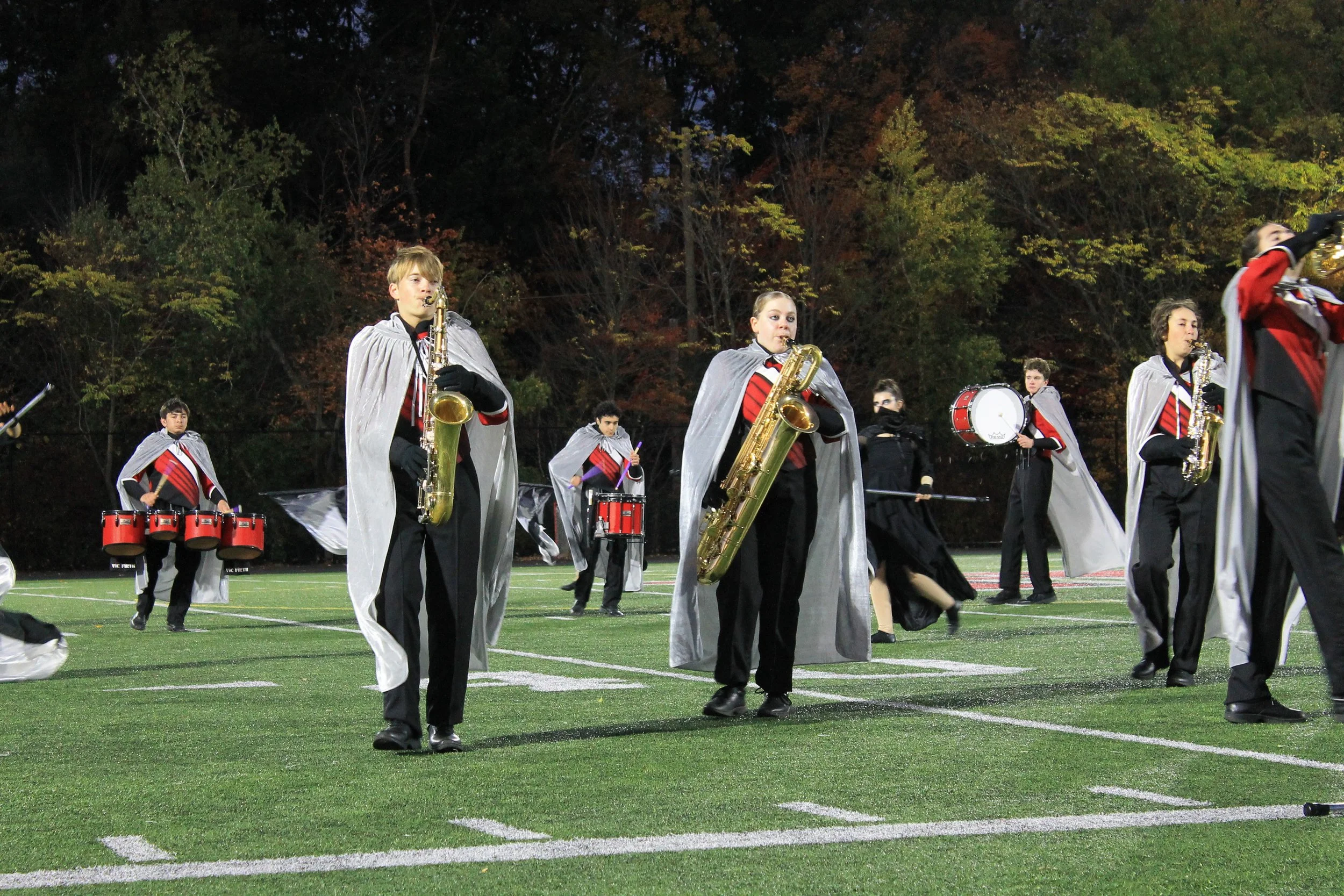 Saxophone players march in formation during the Nevermore show on Hollingsworth Football Field.