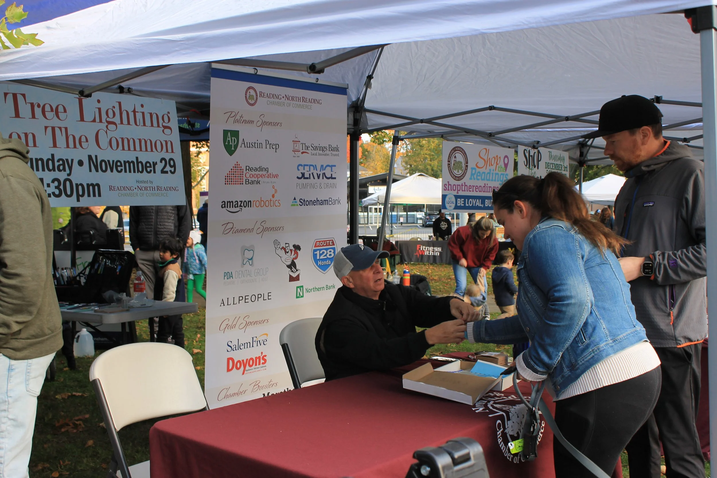Attendees receive wristbands at the Reading-North Reading Chamber of Commerce table.