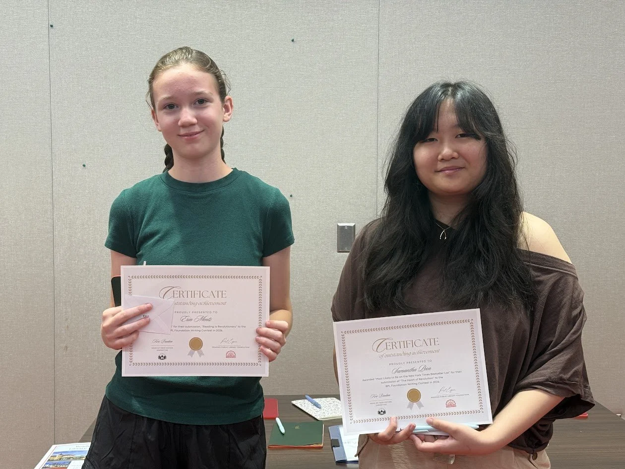 Two teenage girls stand side by side, each holding a framed certificate of achievement from the RPL Foundation Writing Contest.