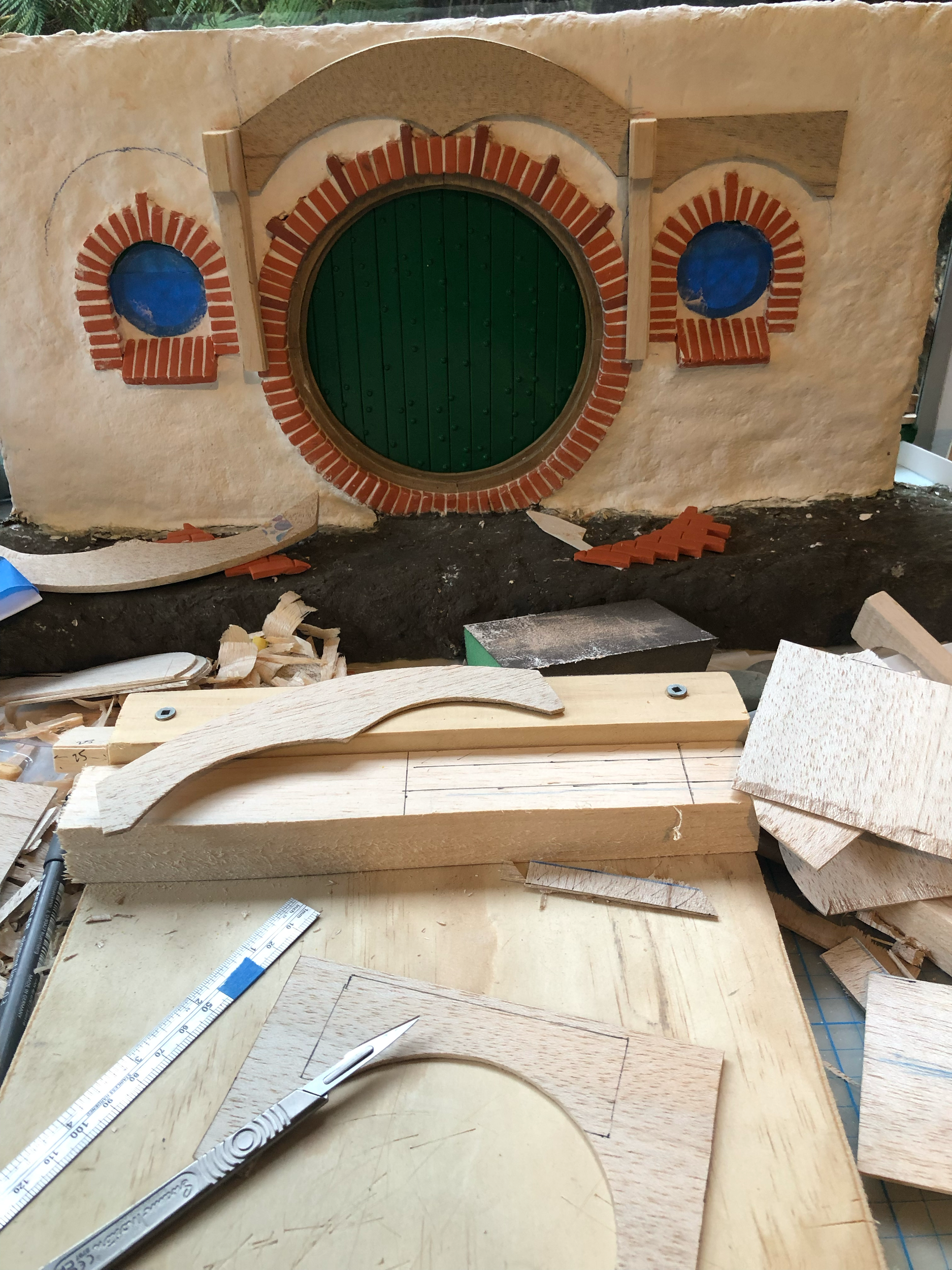 Putting the wood up to test layout. This was one of the hardest steps, figuring out how to sit the central posts on top of the brick but also within the plaster walls behind it, and to be in line with the other wood panel pieces. It took quite a bit 