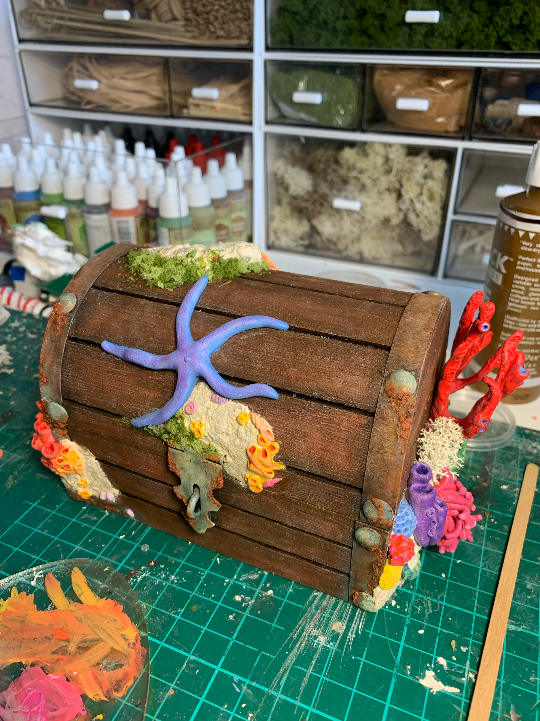 Dressing a prefabricated treasure box with undersea coral and reef sculptures made from epoxy