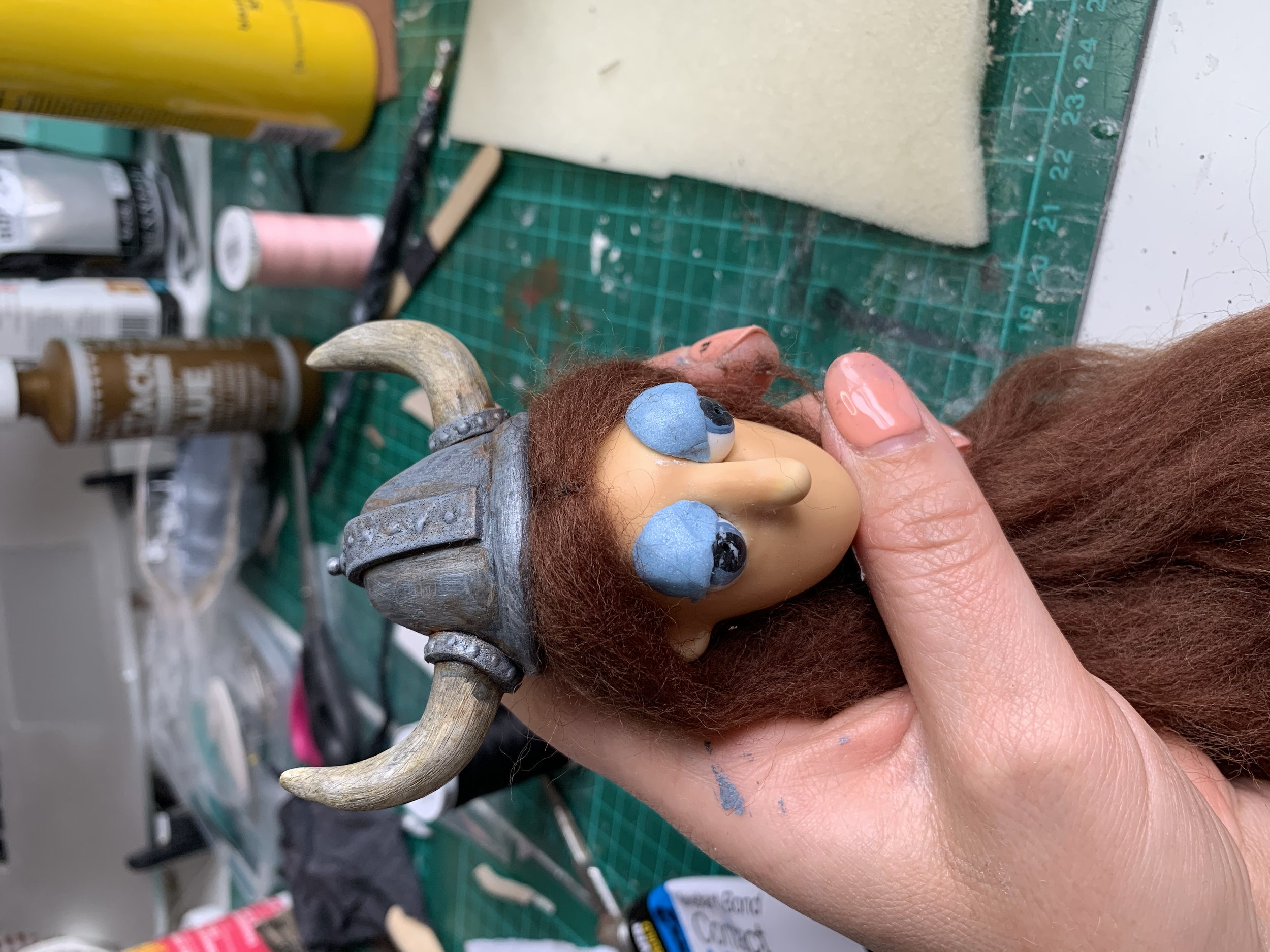 Attaching wig and helmet, adding painted bead eyes and plasticine lids
