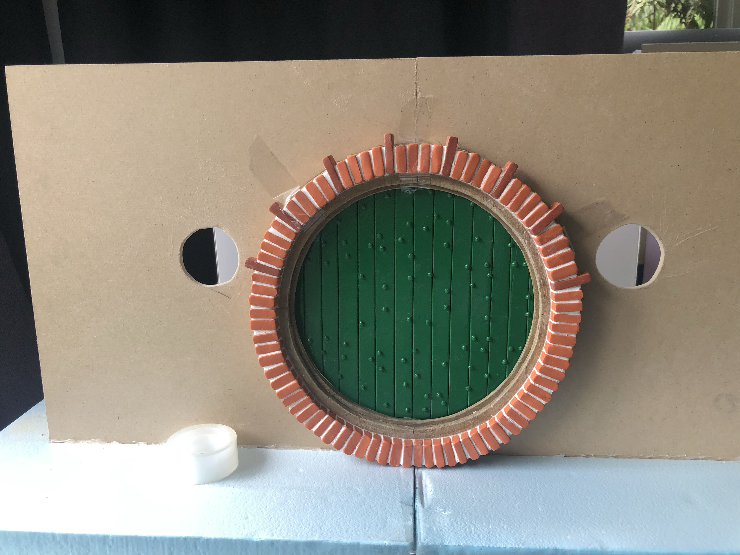 I kept Dremeling until the hole was just right to fit the door and frame into the space. Once the frame was in I decided the window spacing didn’t look optically right so ended up shifting the holes outwards a bit more and filling the old space with